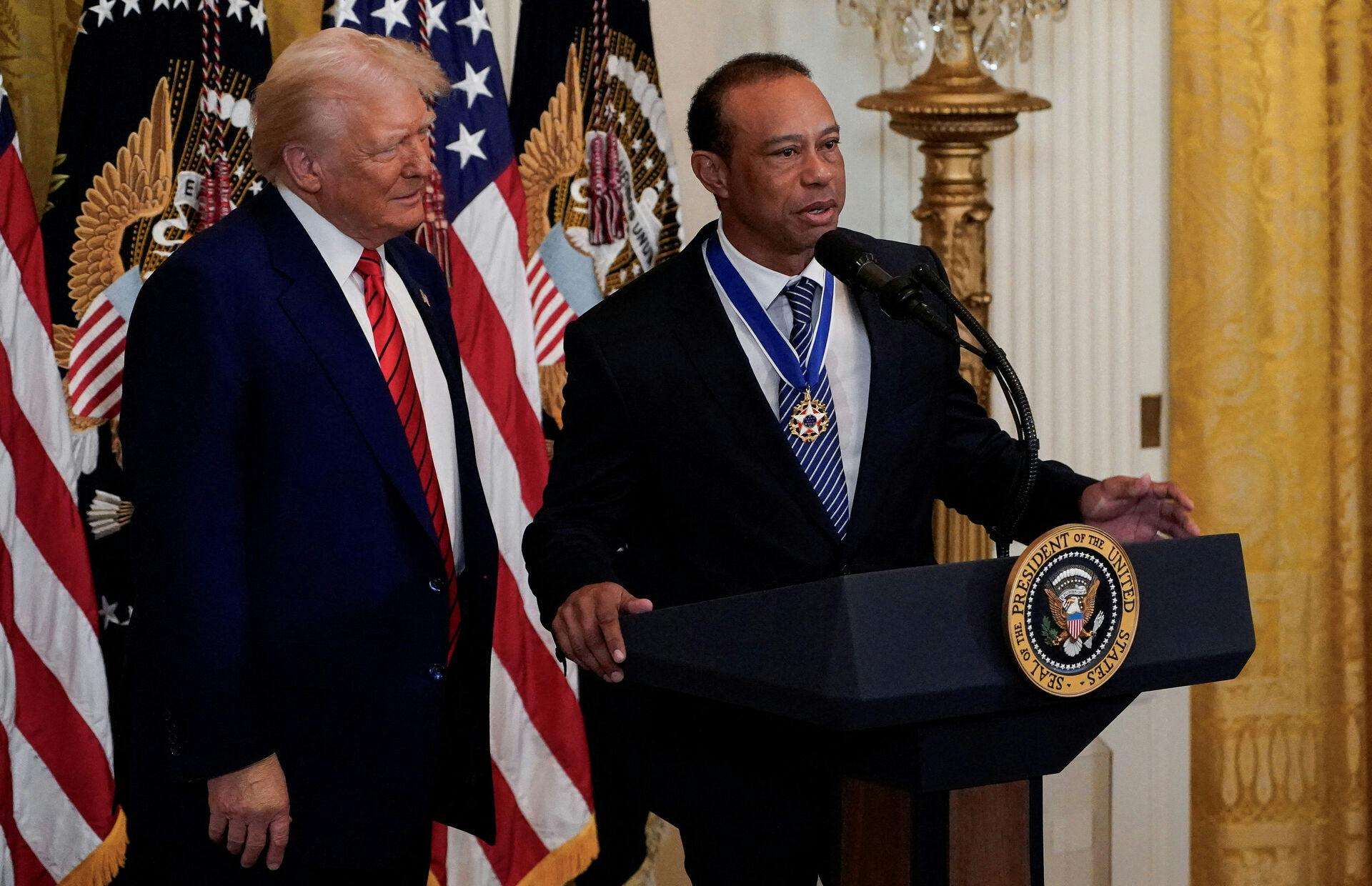 Tiger Woods speaks next to U.S. President Donald Trump during a reception honouring Black History Month in the East Room of the White House in Washington, D.C., U.S., February 20, 2025. REUTERS/Kent Nishimura