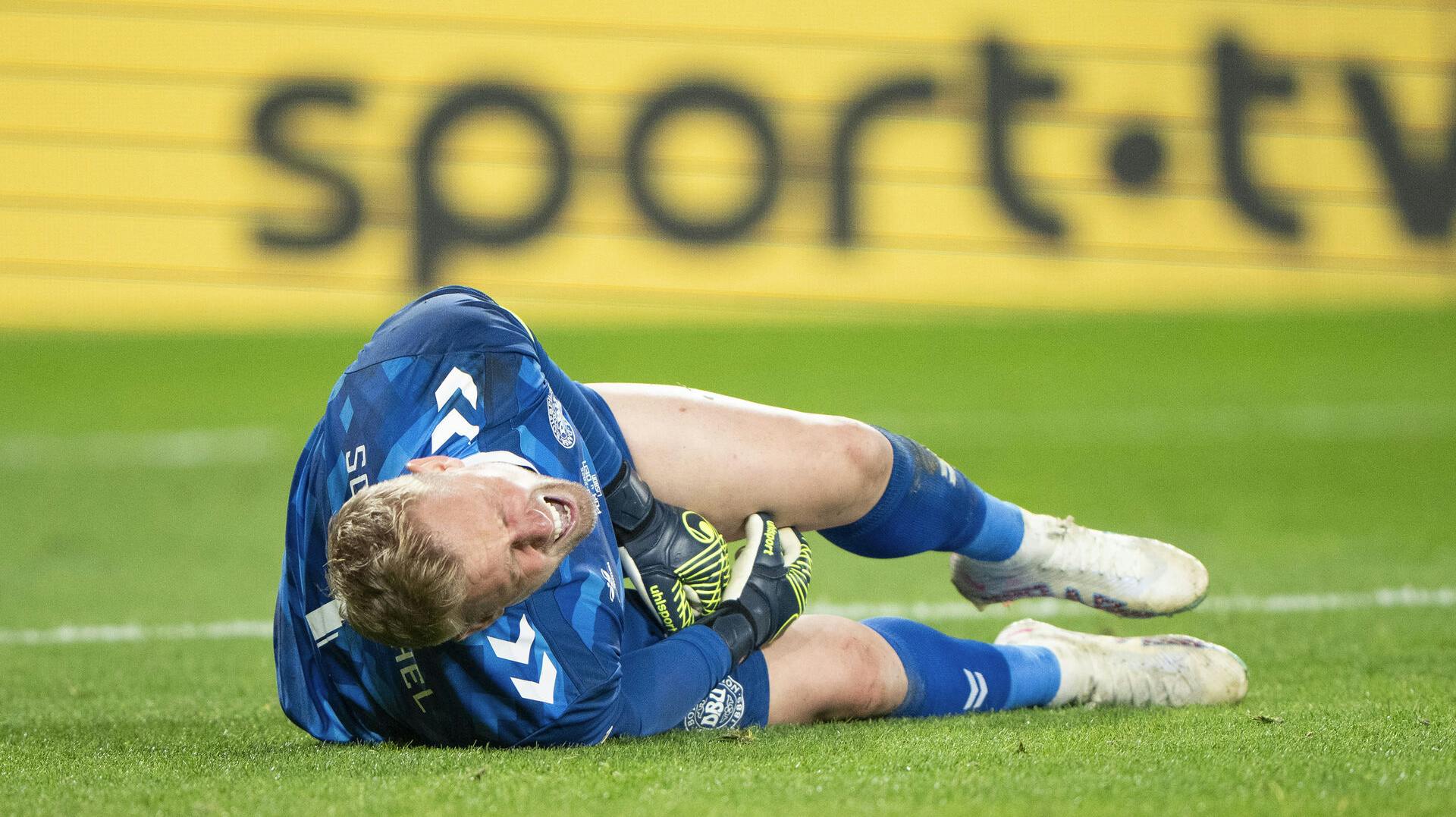 Denmark's goalkeeper Kasper Schmeichel is in pain