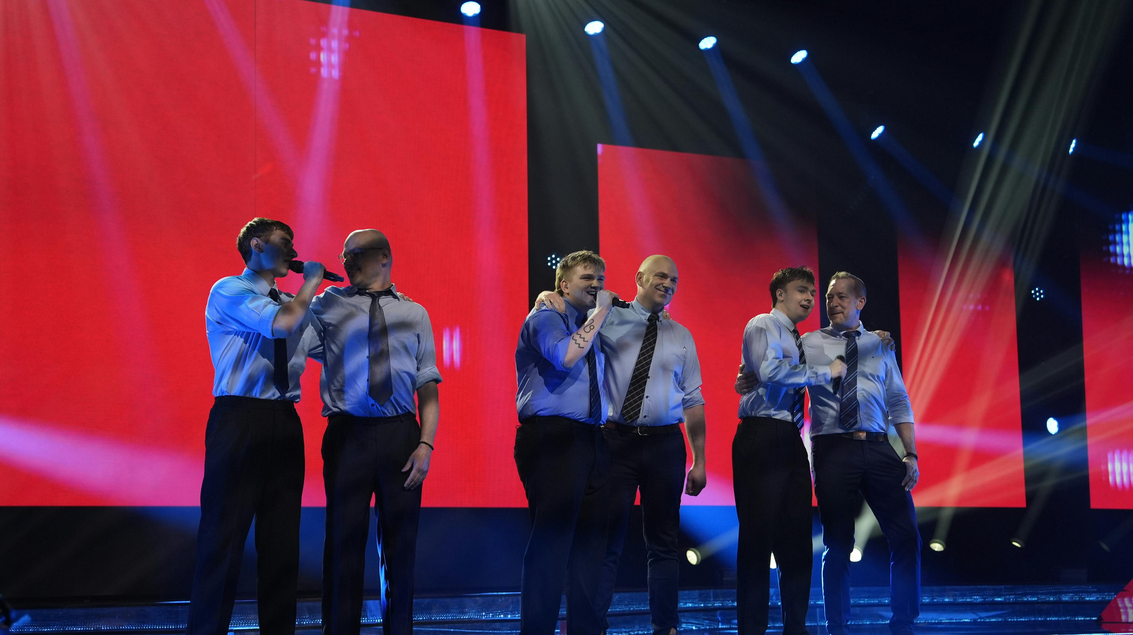 9000 HÅB sammen med deres tre fædre på "X Factor" scenen.