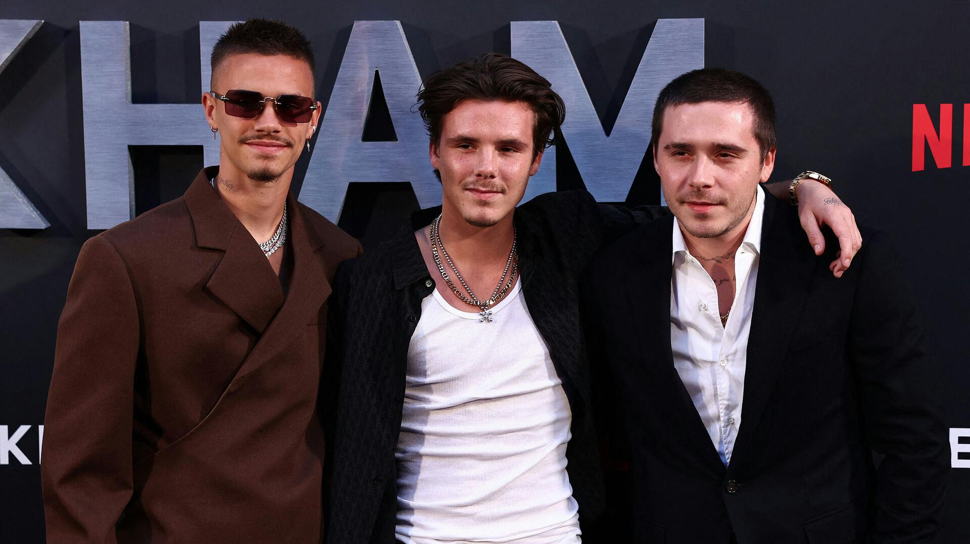 Romeo Beckham (L), Cruz Beckham (C) and thier borther Brooklyn Beckham poses on the red carpet upon arrival to attend the Premiere of "Beckham" in London on October 3, 2023. HENRY NICHOLLS / AFP