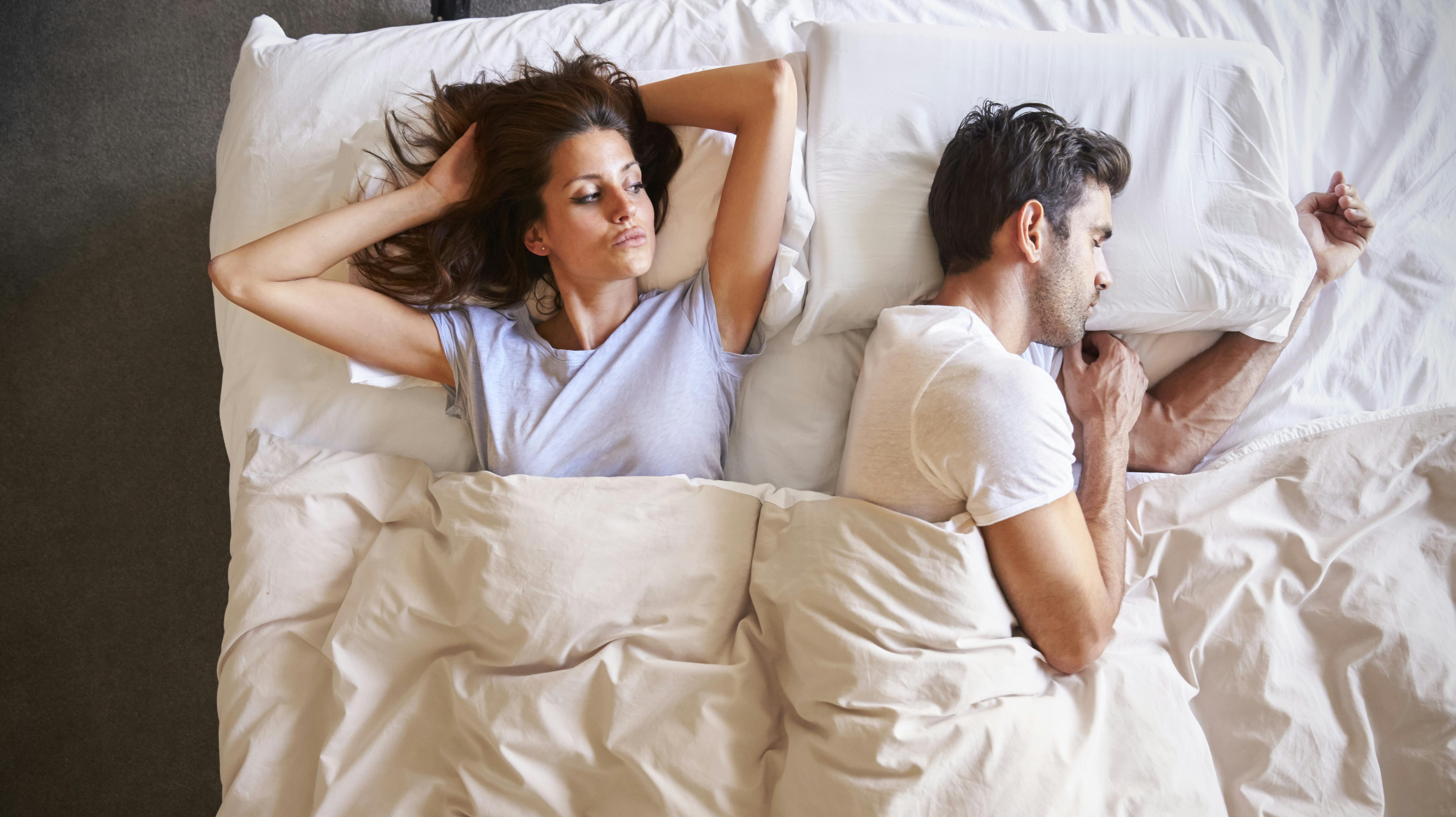 Overhead View Of Couple With Relationship Problems Lying In Bed