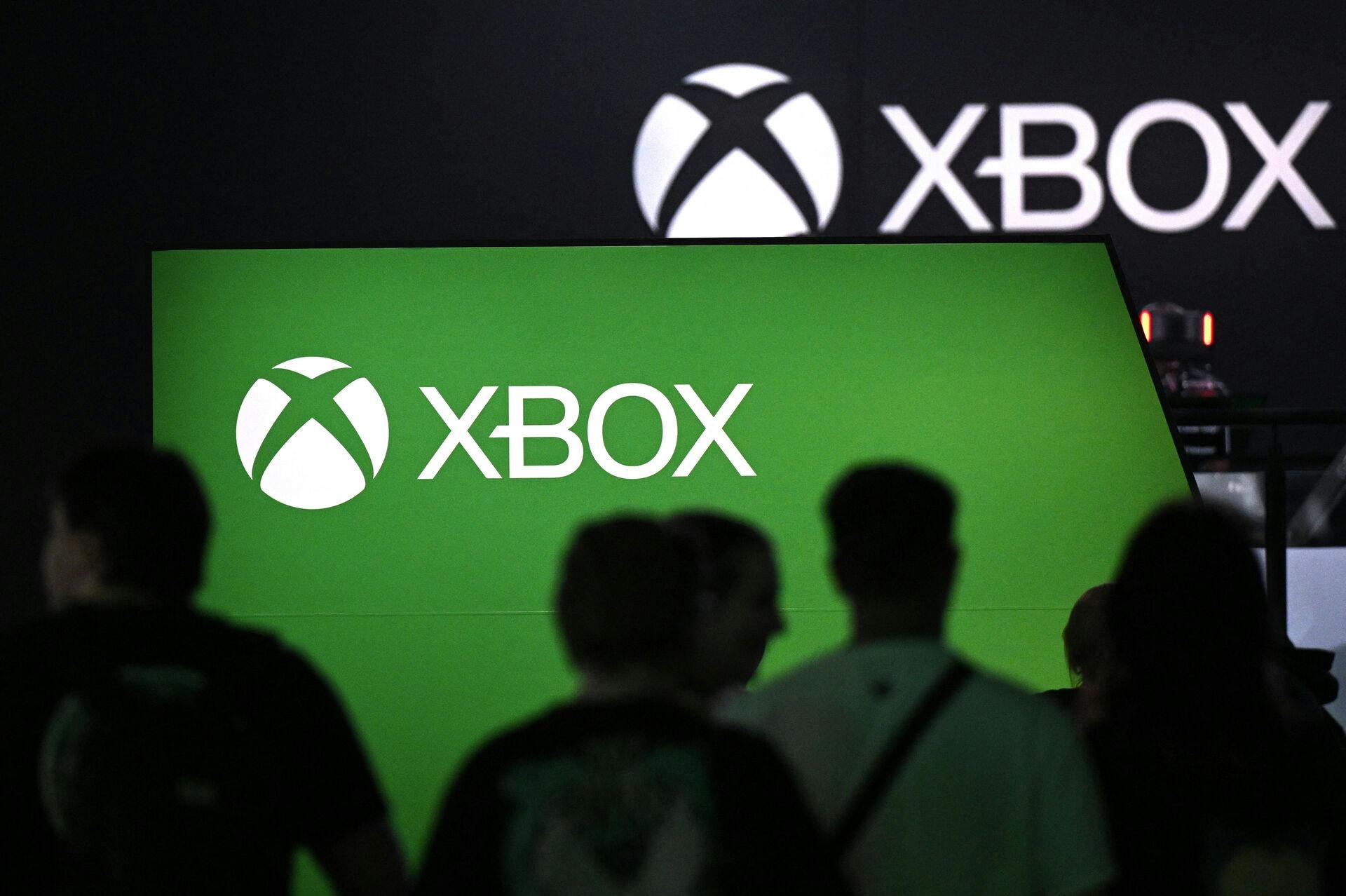 Visitors stand at the Xbox booth at the Gamescom video game fair in Cologne, western Germany, on August 23, 2023. According to the organisers, around 1, 100 exhibitors from 53 countries will be presenting their products during the fair running until August 27, 2023. Ina FASSBENDER / AFP