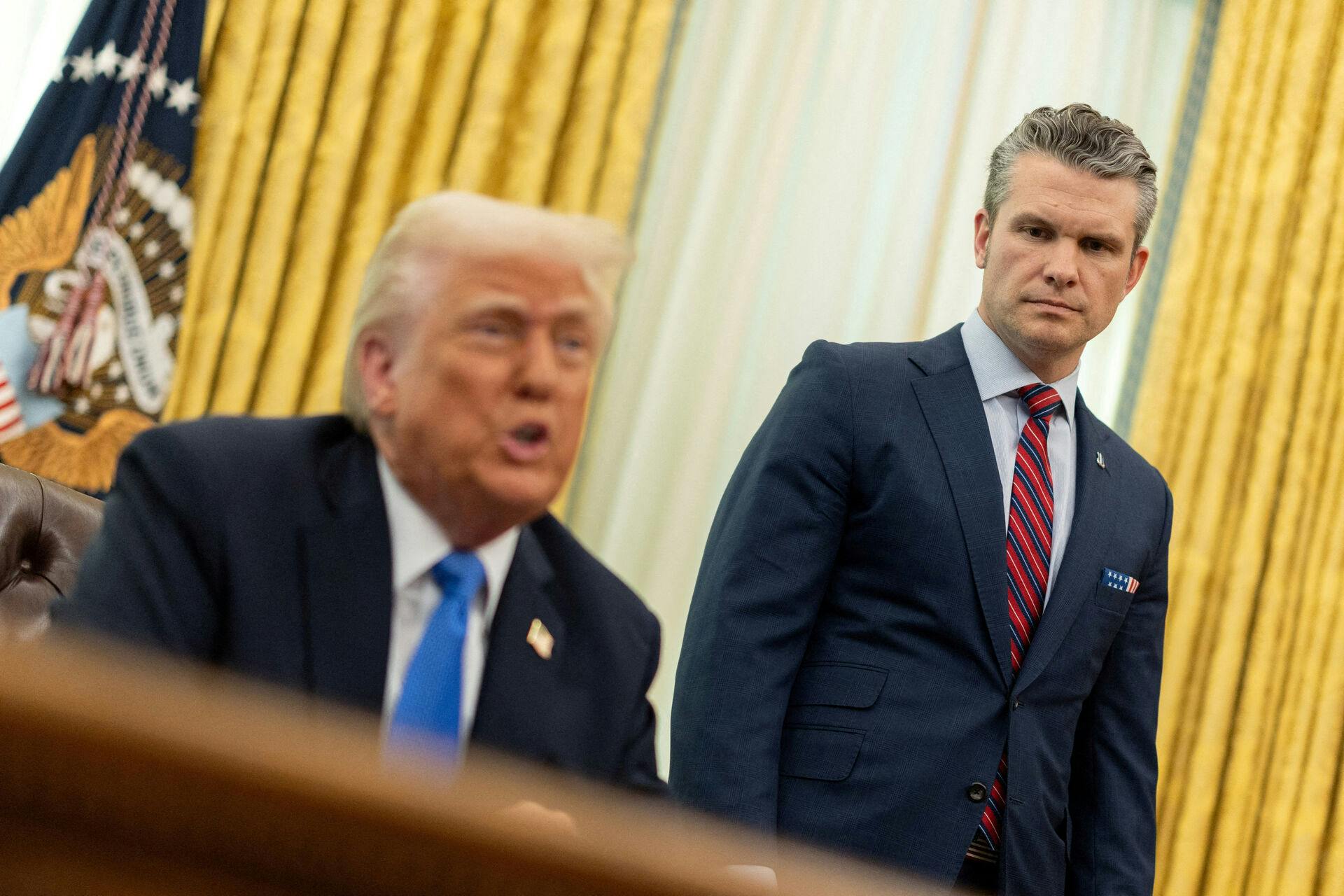 FILE PHOTO: U.S. Defense Secretary Pete Hegseth looks on, as President Donald Trump delivers remarks, in the Oval Office at the White House, in Washington, D.C., U.S., March 21, 2025. REUTERS/Carlos Barria/File Photo