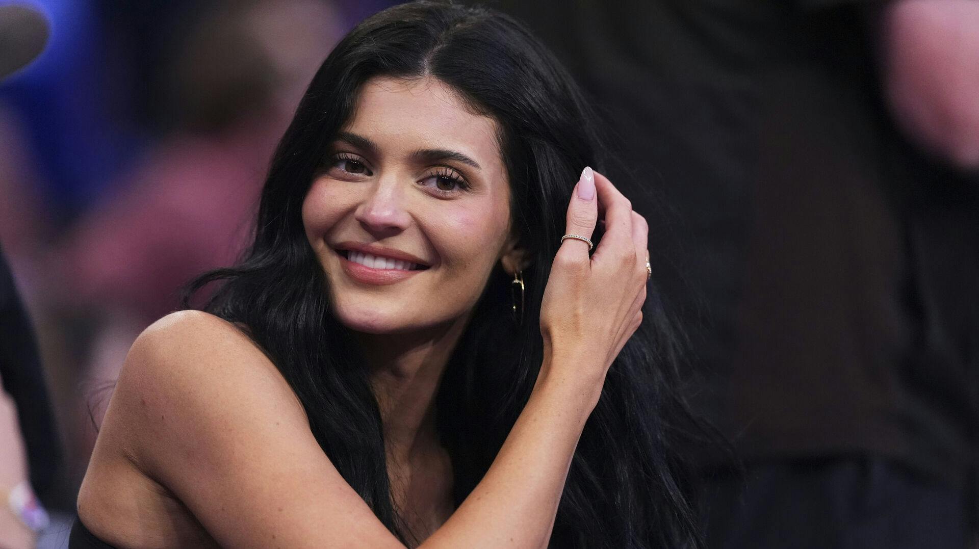 Kylie Jenner talks to colleagues during the second half of Game 4 in the Eastern Conference semifinals of the NBA basketball playoffs between the New York Knicks and the Boston Celtics Monday, May 12, 2025, in New York. (AP Photo/Frank Franklin II)