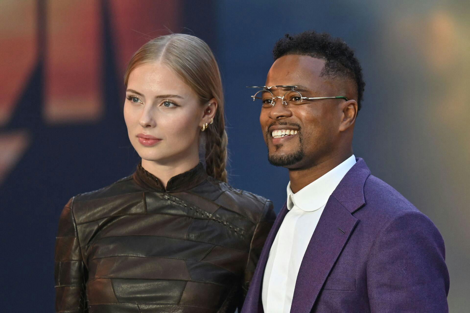Danish model Margaux Alexandra (L) and Former French International footballer Patrice Evra (R) pose on the red carpet upon arrival for the UK premiere of the film "Top Gun: Maverick" in London, on May 19, 2022. (Photo by JUSTIN TALLIS / AFP)
