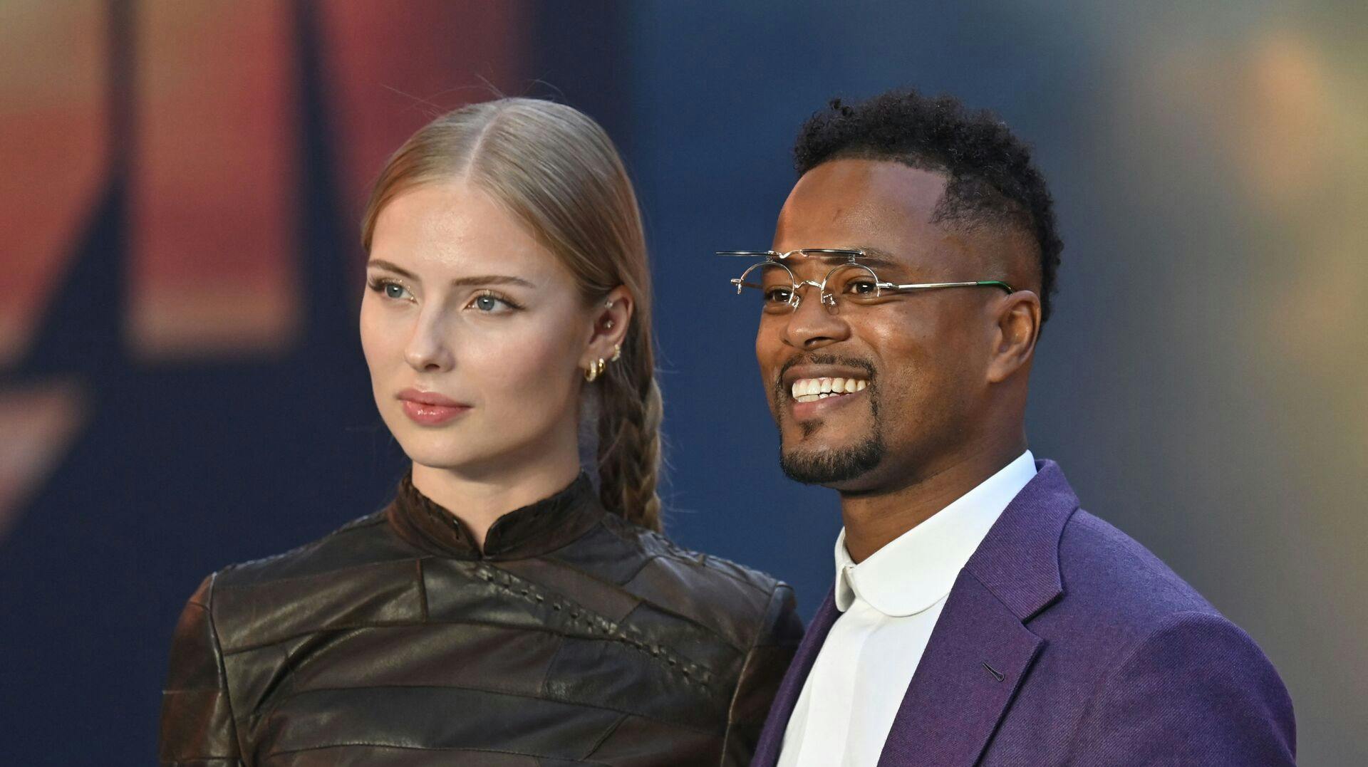 Danish model Margaux Alexandra (L) and Former French International footballer Patrice Evra (R) pose on the red carpet upon arrival for the UK premiere of the film "Top Gun: Maverick" in London, on May 19, 2022. (Photo by JUSTIN TALLIS / AFP)
