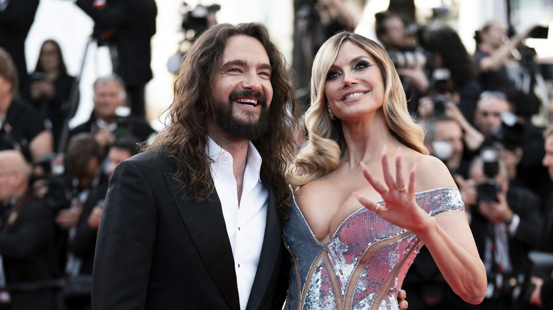 Tom Kaulitz, left, and Heidi Klum pose for photographers
