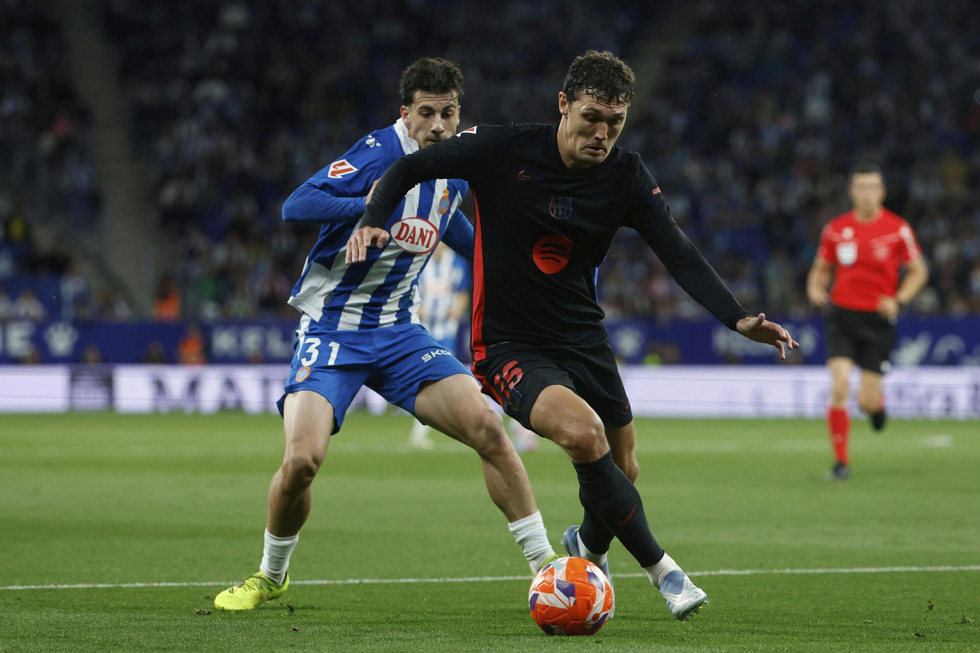 Espanyol's Antoniu Roca, left, fights for the ball with Barcelona's Andreas Christensen during a Spanish La Liga soccer match between Barcelona and Espanyol at Lluis Companys Olympic Stadium in Barcelona, Spain, Thursday, May 15, 2025. (AP Photo/Joan Monfort)