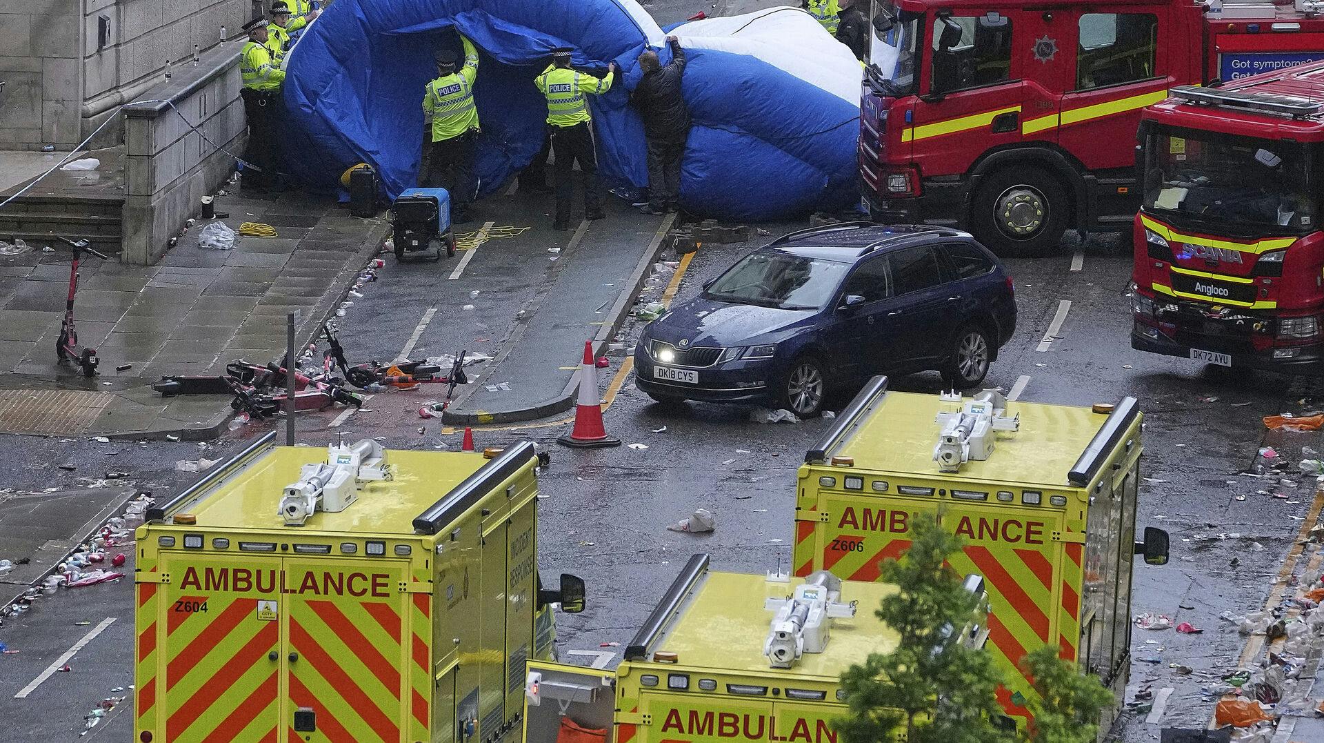 Police and emergency personnel deal with an incident after a car collided with pedestrians near the Liver Building during the Premier League winners parade in Liverpool, England, Monday, May 26, 2025.(AP Photo/Jon Super)