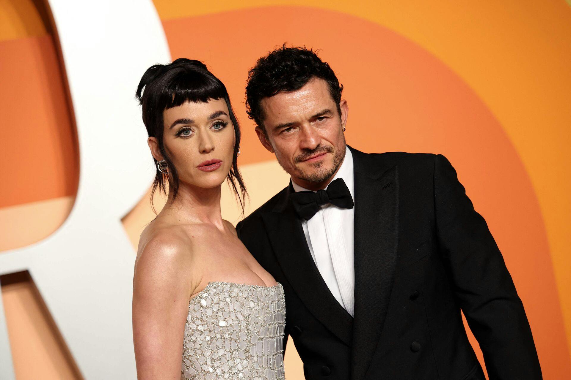 US singer Katy Perry (L) and English actor Orlando Bloom attend the Vanity Fair Oscar Party at the Wallis Annenberg Center for the Performing Arts in Beverly Hills, California, on March 2, 2025. (Photo by Michael Tran / AFP)