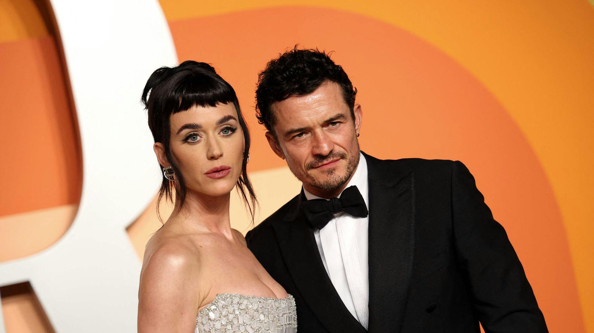 US singer Katy Perry (L) and English actor Orlando Bloom attend the Vanity Fair Oscar Party at the Wallis Annenberg Center for the Performing Arts in Beverly Hills, California, on March 2, 2025. (Photo by Michael Tran / AFP)