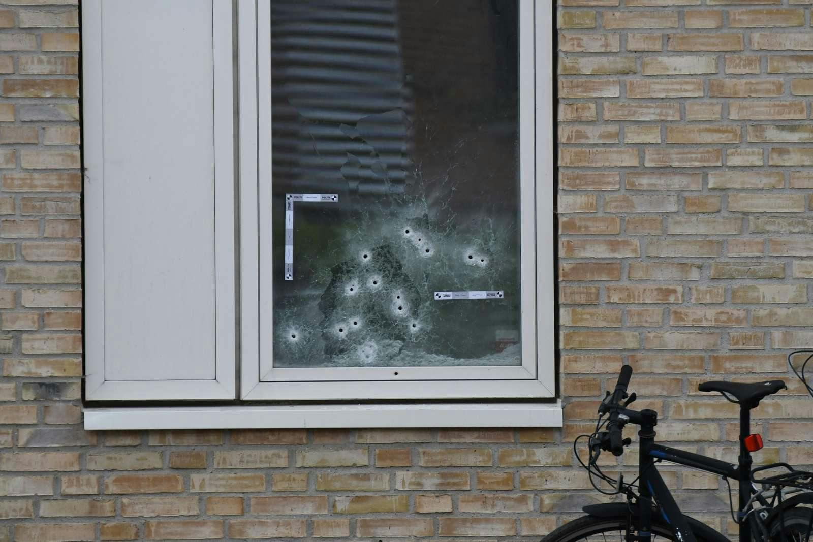 Der kan tælles omkring 17 skudhuller i ruden ind til lejligheden, hvorfra skuddene faldt.
