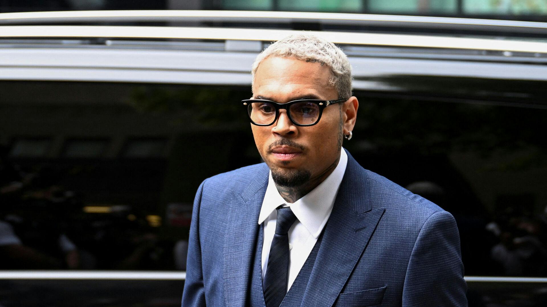 Musikeren Chris Brown afviser, at have overfaldet en producer med en flaske på en natklub.