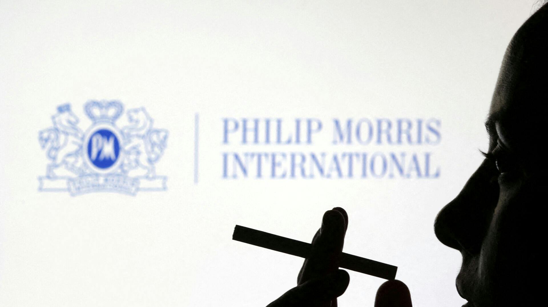 FILE PHOTO: A woman poses with a cigarette in front of Philip Morris International logo in this illustration taken July 26, 2022. REUTERS/Dado Ruvic/Illustration/File Photo