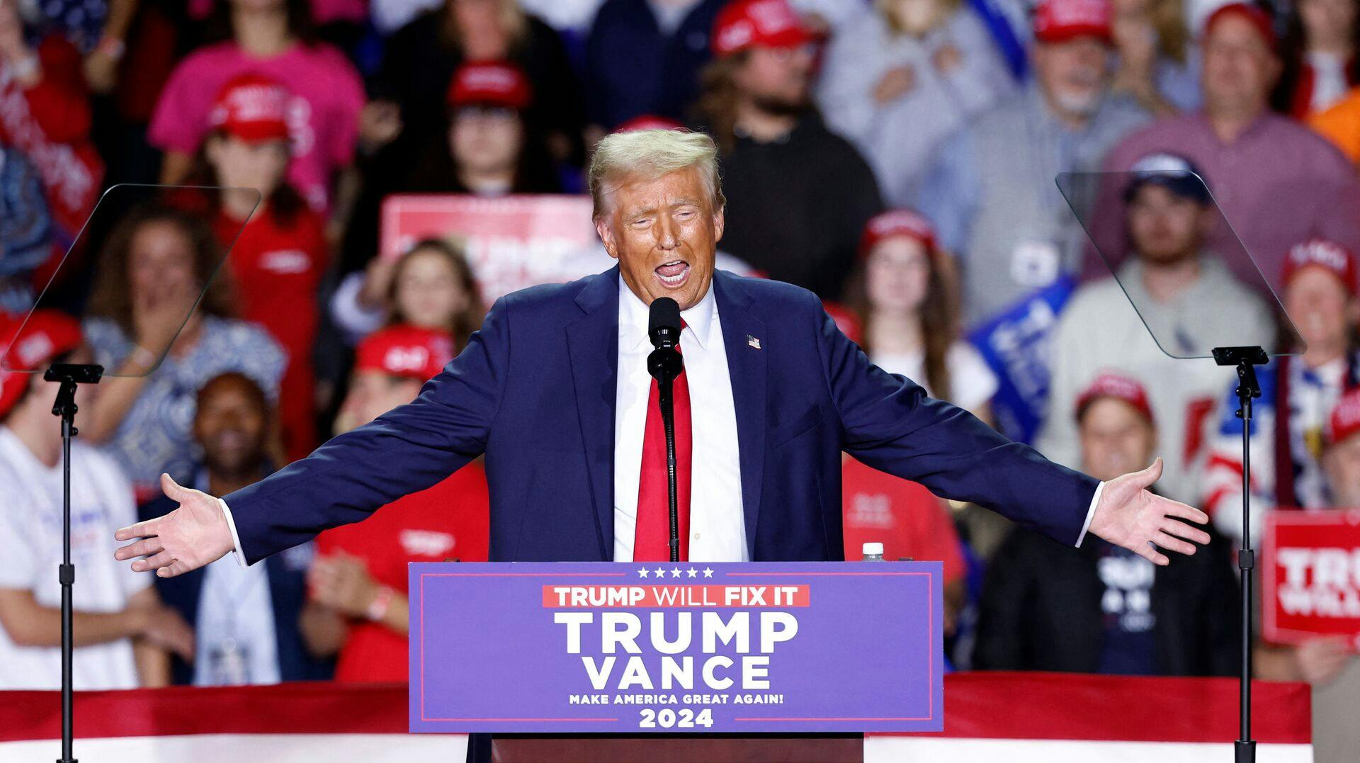 TOPSHOT - Former US President and Republican presidential candidate Donald Trump speaks during a campaign rally at Van Andel Arena in Grand Rapids, Michigan on November 5, 2024. (Photo by KAMIL KRZACZYNSKI / AFP)