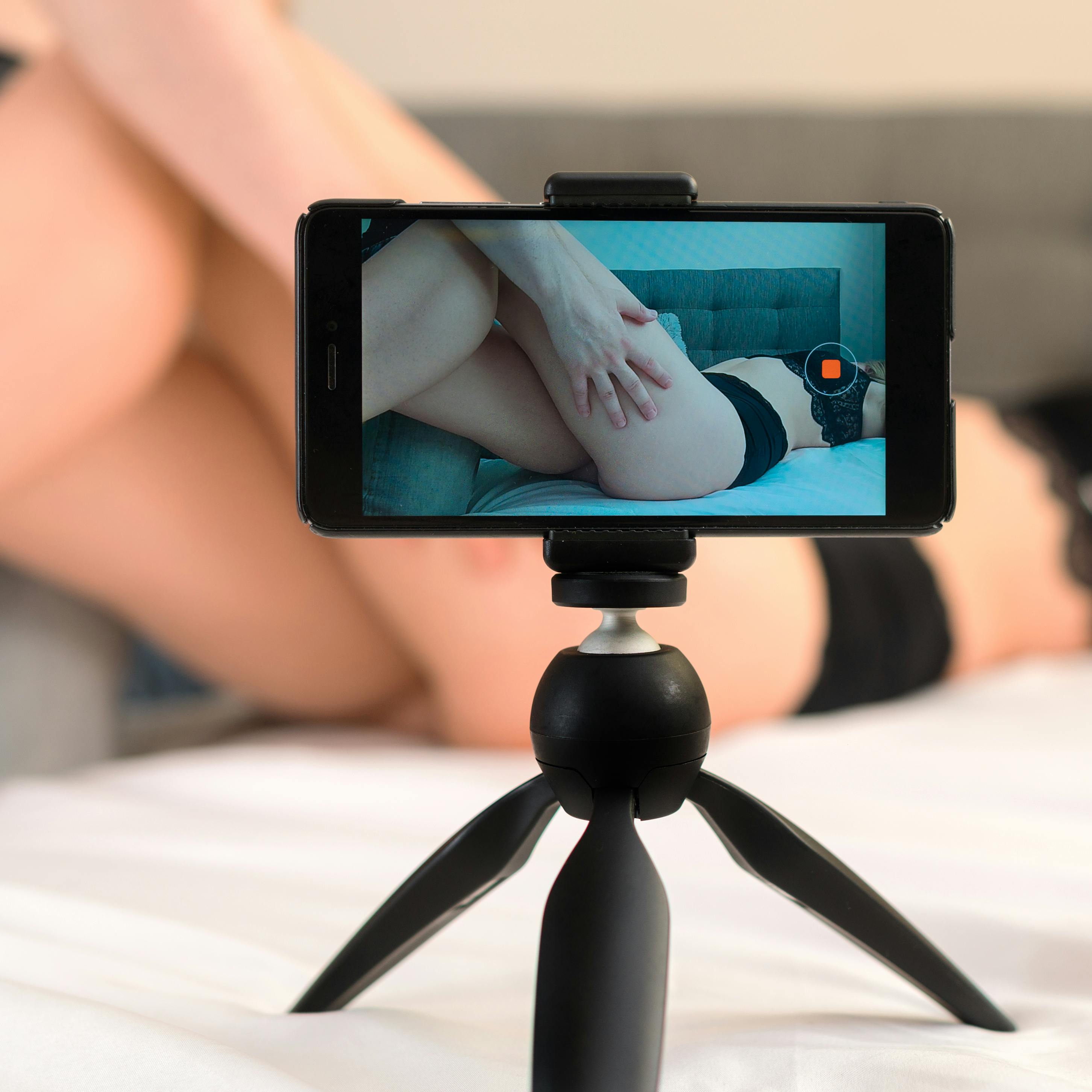 Couple recording their adult video on mobile phone.