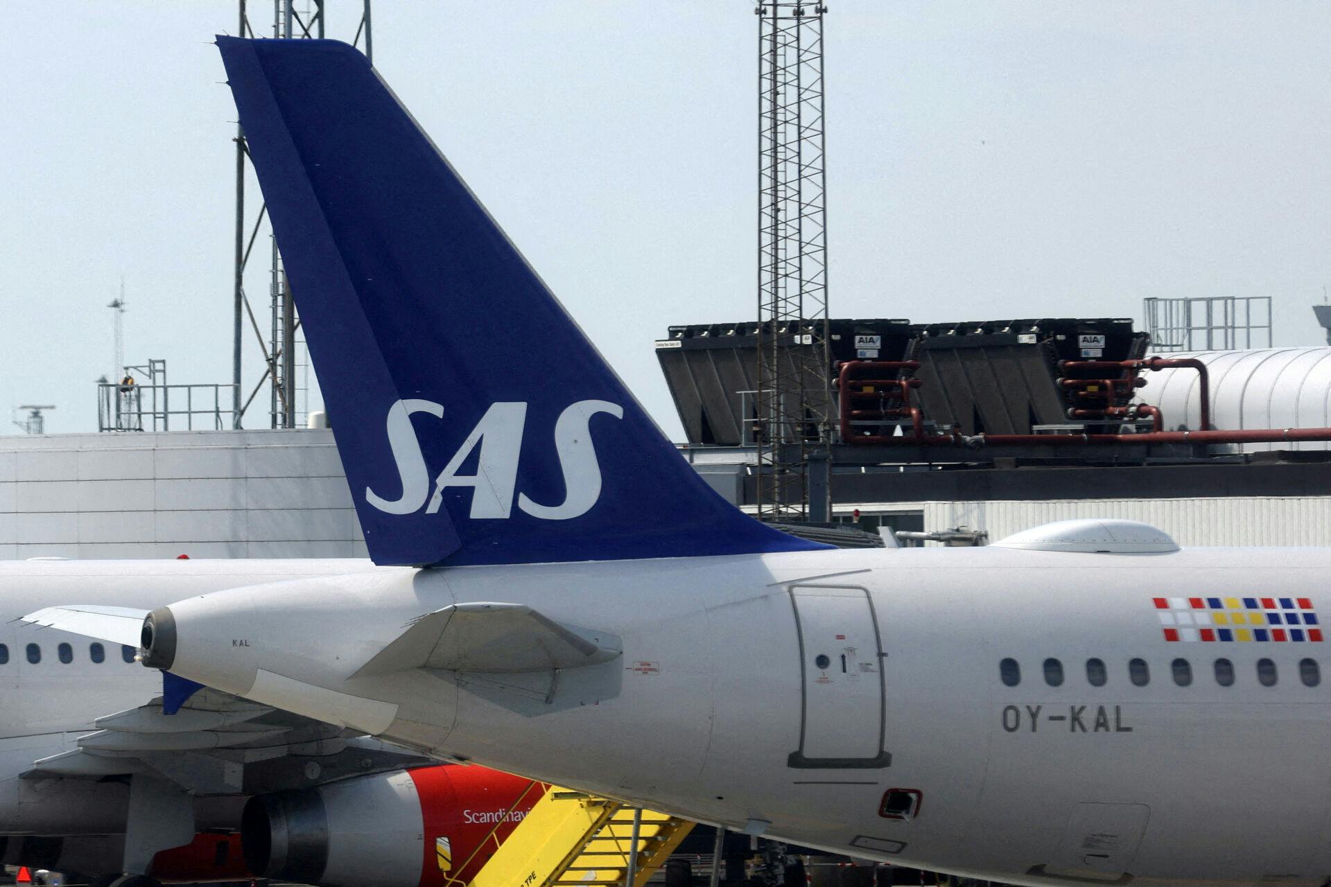 FILE PHOTO: The tail fin of a parked Scandinavian Airlines (SAS) airplane is seen on the tarmac at Copenhagen Airport Kastrup in Copenhagen, Denmark, July 3, 2022. REUTERS/Andrew Kelly//File Photo