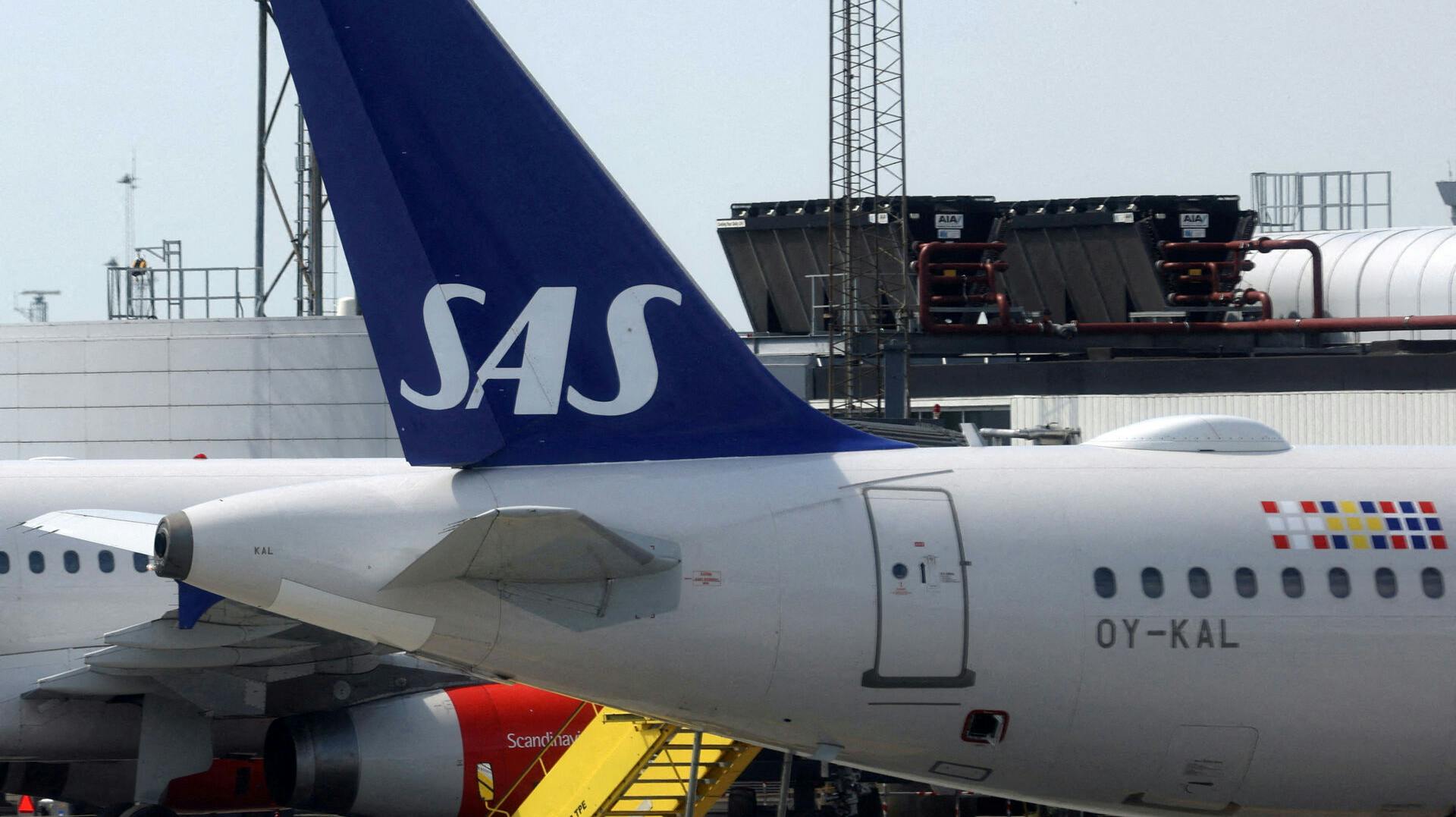FILE PHOTO: The tail fin of a parked Scandinavian Airlines (SAS) airplane is seen on the tarmac at Copenhagen Airport Kastrup in Copenhagen, Denmark, July 3, 2022. REUTERS/Andrew Kelly//File Photo