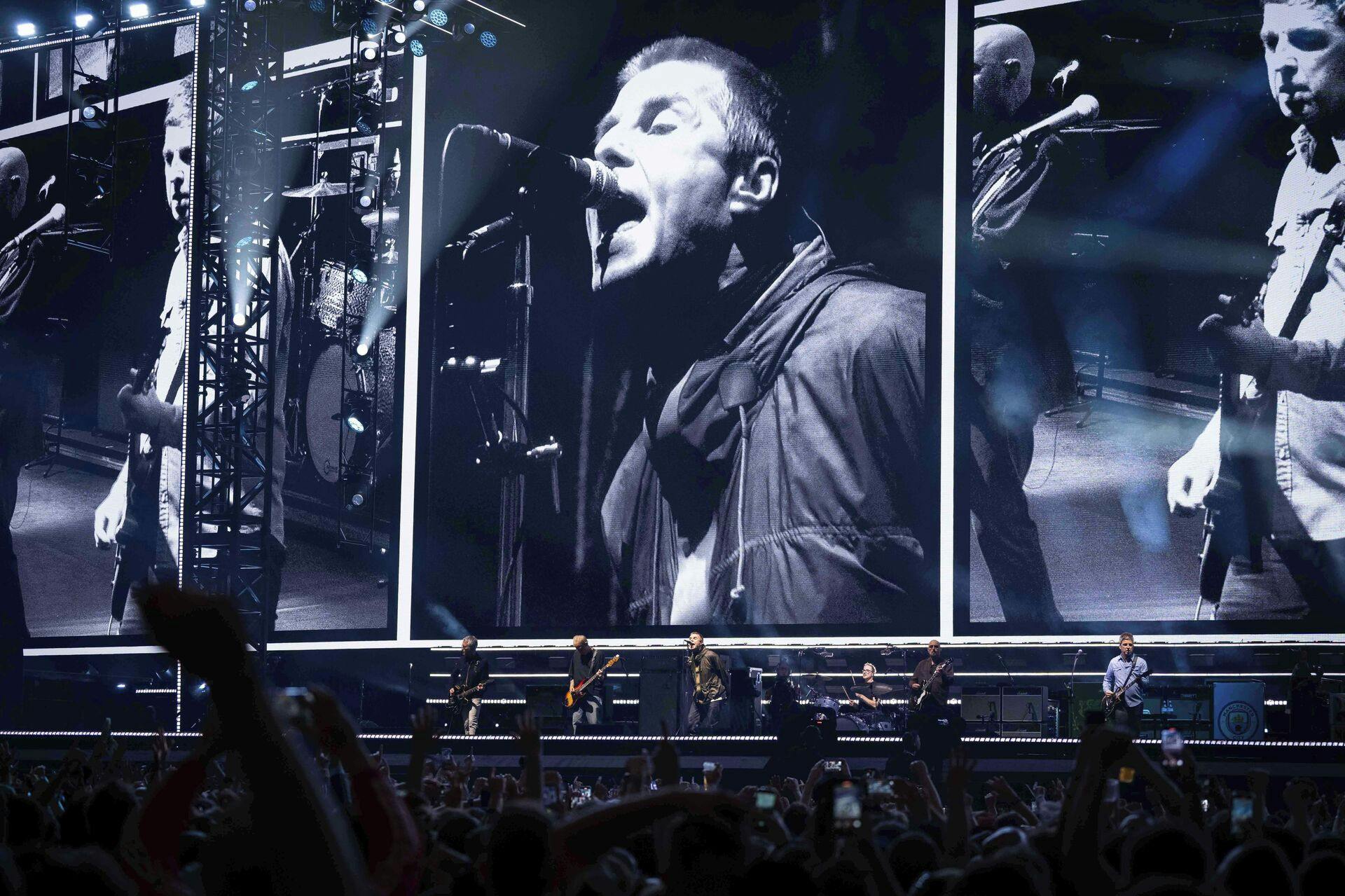 Liam Gallagher, left, and Noel Gallagher, right, from the band Oasis perform during their reunion concert on Friday, July 4, 2025, in Cardiff. (Photo by Scott A Garfitt/Invision/AP)