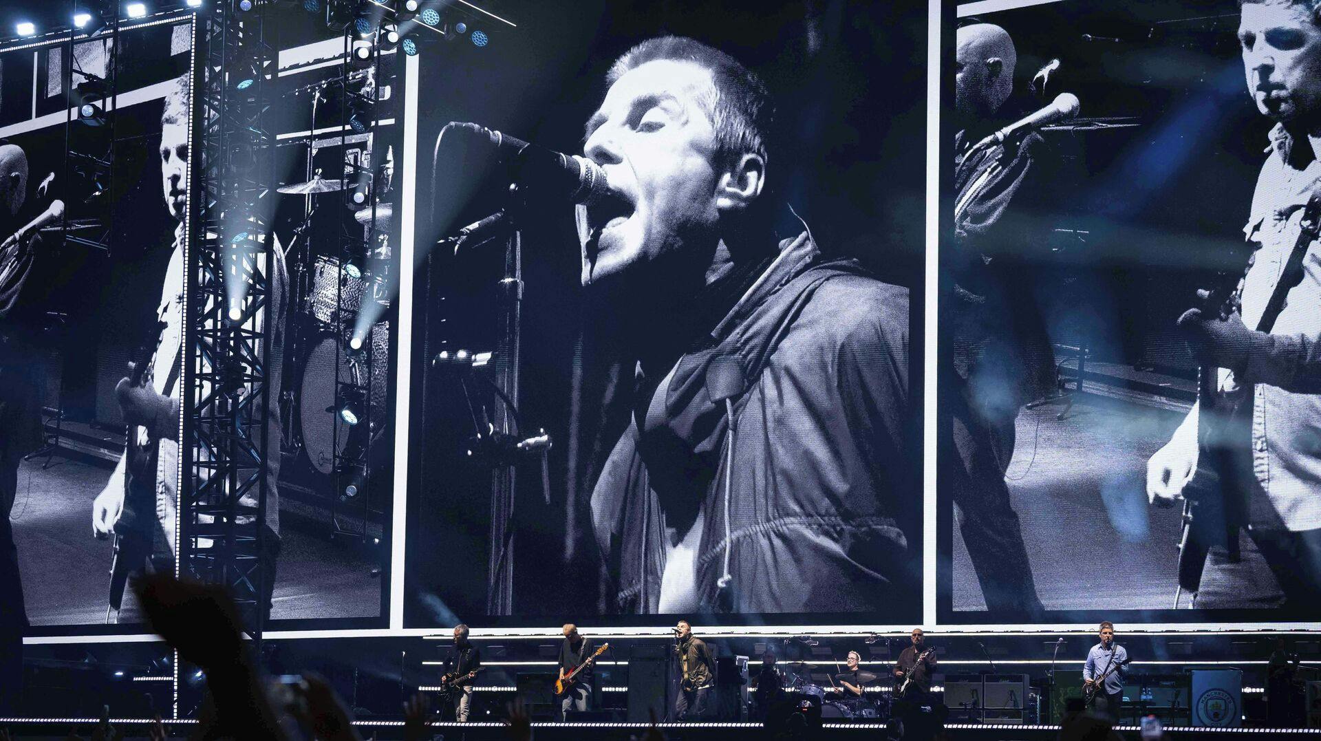 Liam Gallagher, left, and Noel Gallagher, right, from the band Oasis perform during their reunion concert on Friday, July 4, 2025, in Cardiff. (Photo by Scott A Garfitt/Invision/AP)