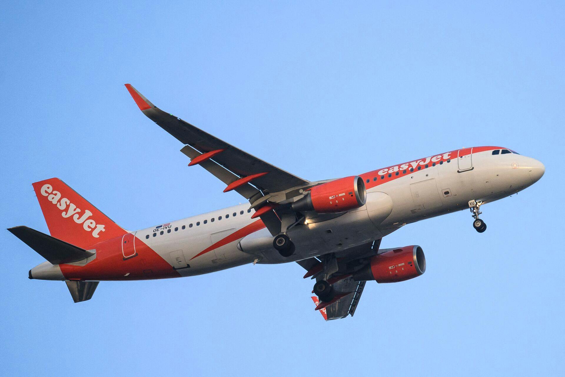 An EasyJet plane flies over the city of Nantes, western France, on April 23, 2025. (Photo by Loic VENANCE / AFP)