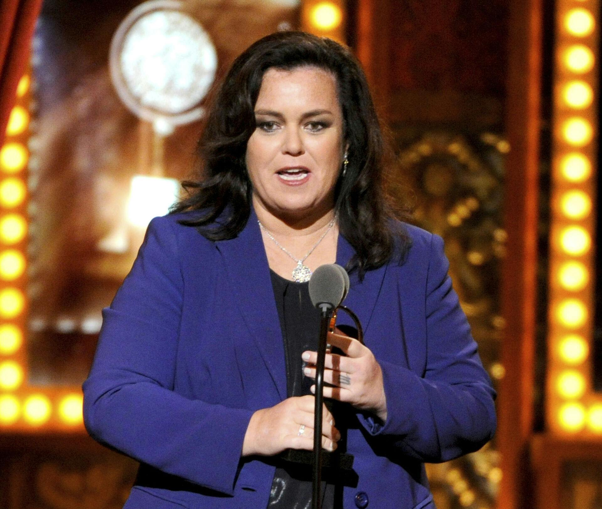 FILE - In this June 8, 2014, file photo, Rosie O'Donnell accepts the Isabelle Stevenson Award on stage at the 68th annual Tony Awards in New York. O'Donnell confirmed to People magazine on Monday, Oct. 22, 2018, her engagement to Elizabeth Rooney. (Photo by Evan Agostini/Invision/AP, File)