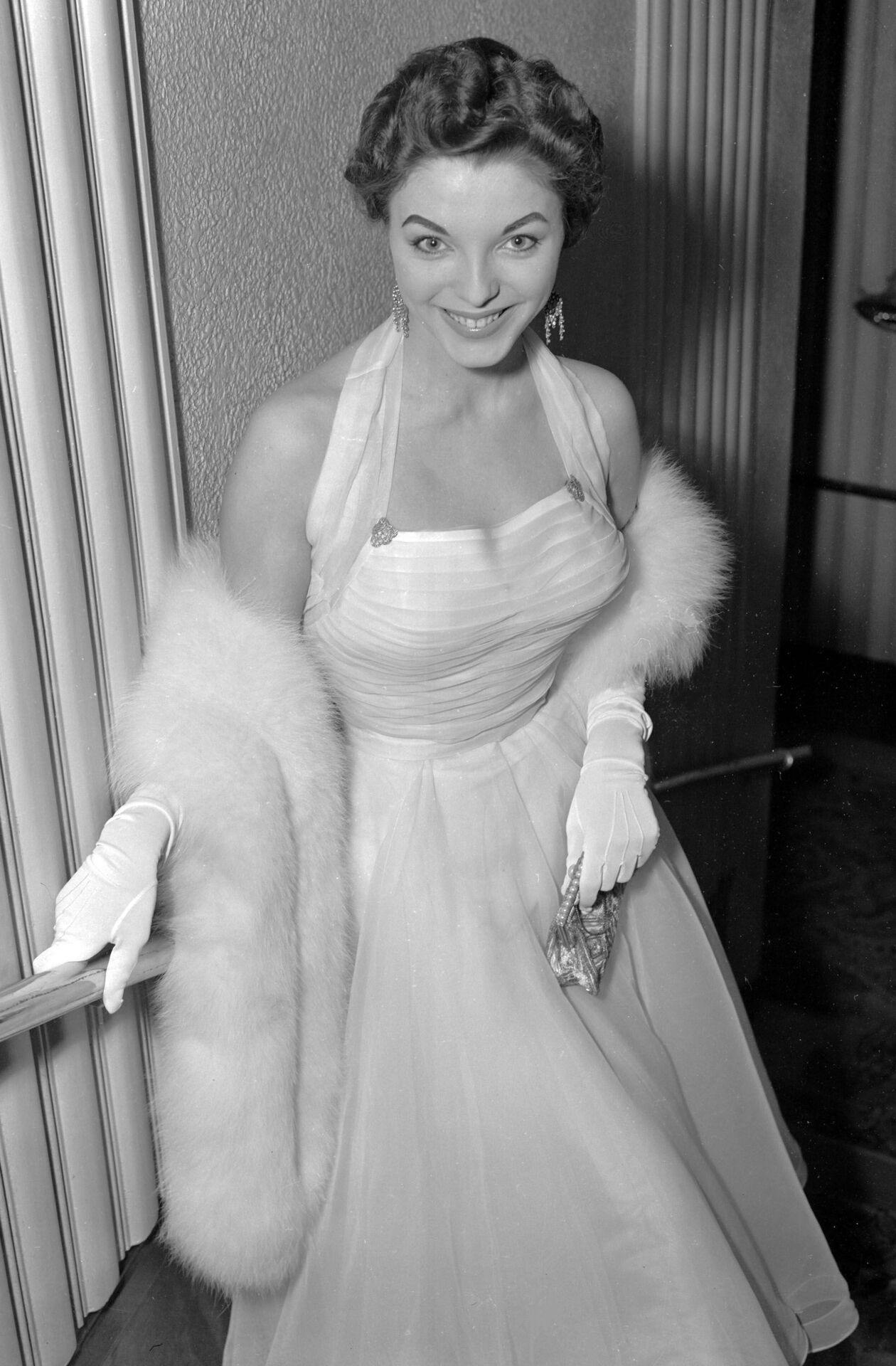 British actress Joan Collins arrives at the Odeon Cinema at Marble Arch, London, March 6, 1952, for the premiere of "I Believe In You". (AP Photo)