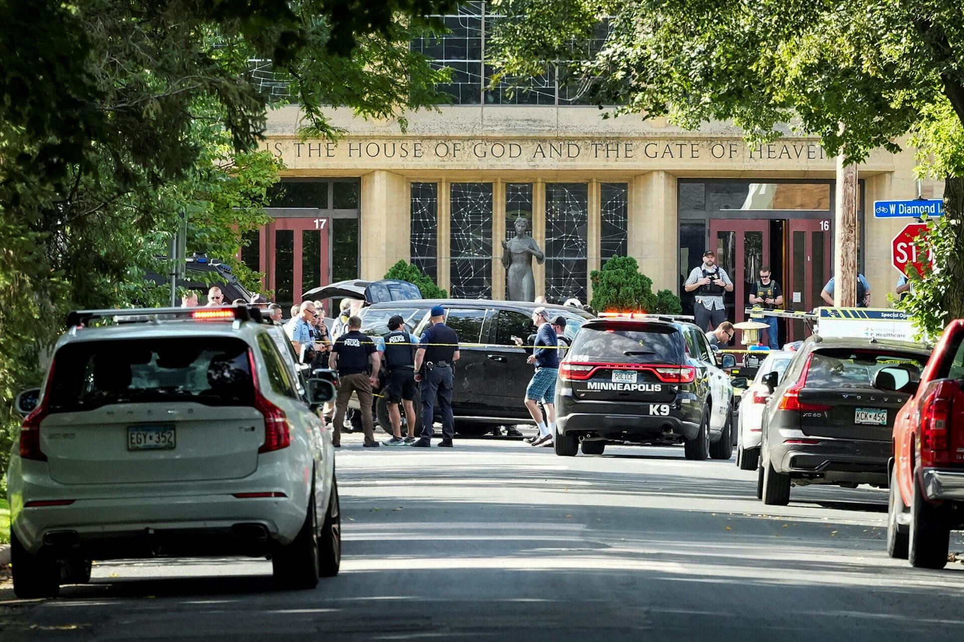 Law enforcement officers gather outside Annunciation Church following a mass shooting event, in Minneapolis, Minnesota, U.S., August 27, 2025. REUTERS/Tim Evans