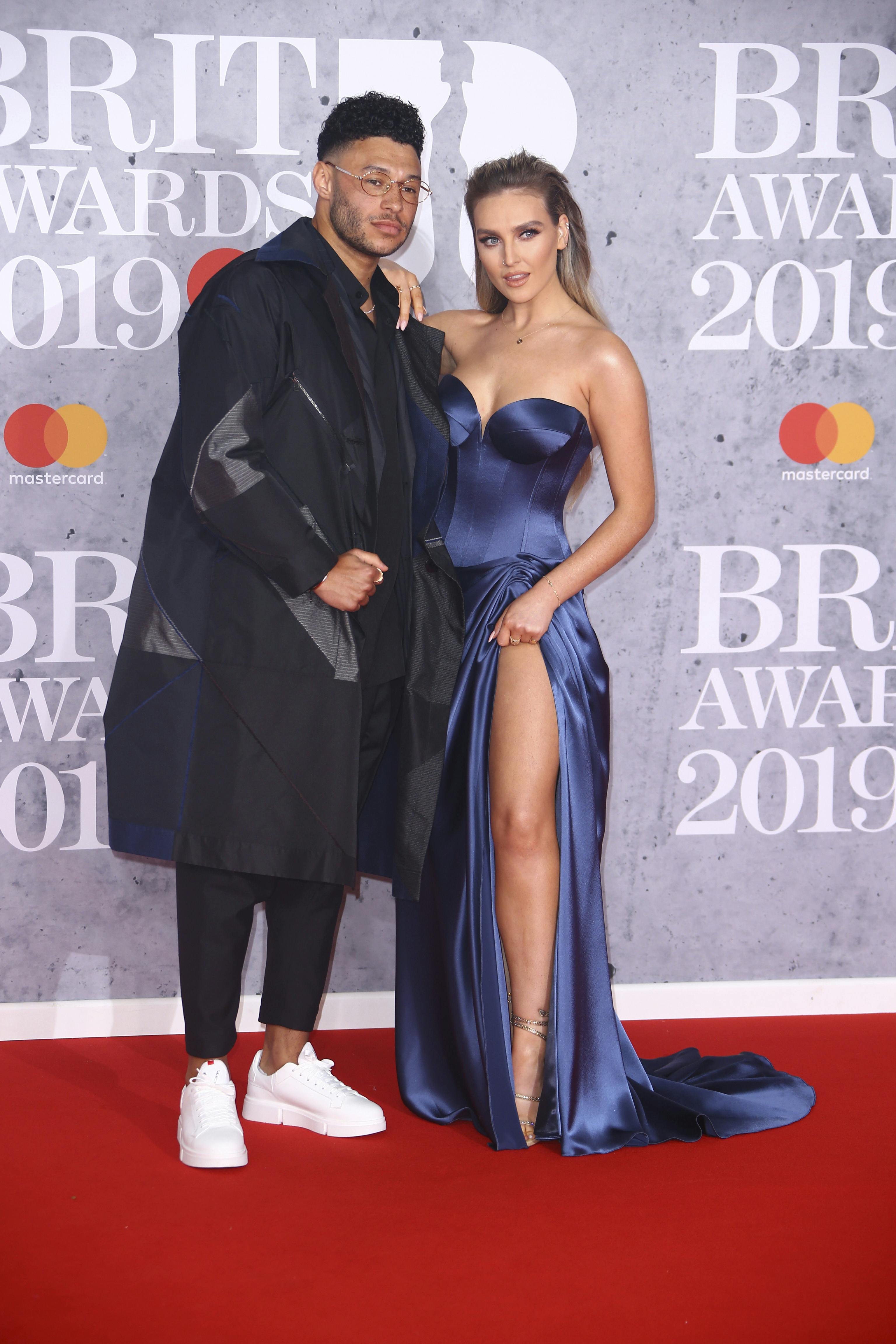 Alex Oxlade-Chamberlain and Perrie Edwards poses for photographers upon arrival at the Brit Awards in London, Wednesday, Feb. 20, 2019. (Photo by Joel C Ryan/Invision/AP)
