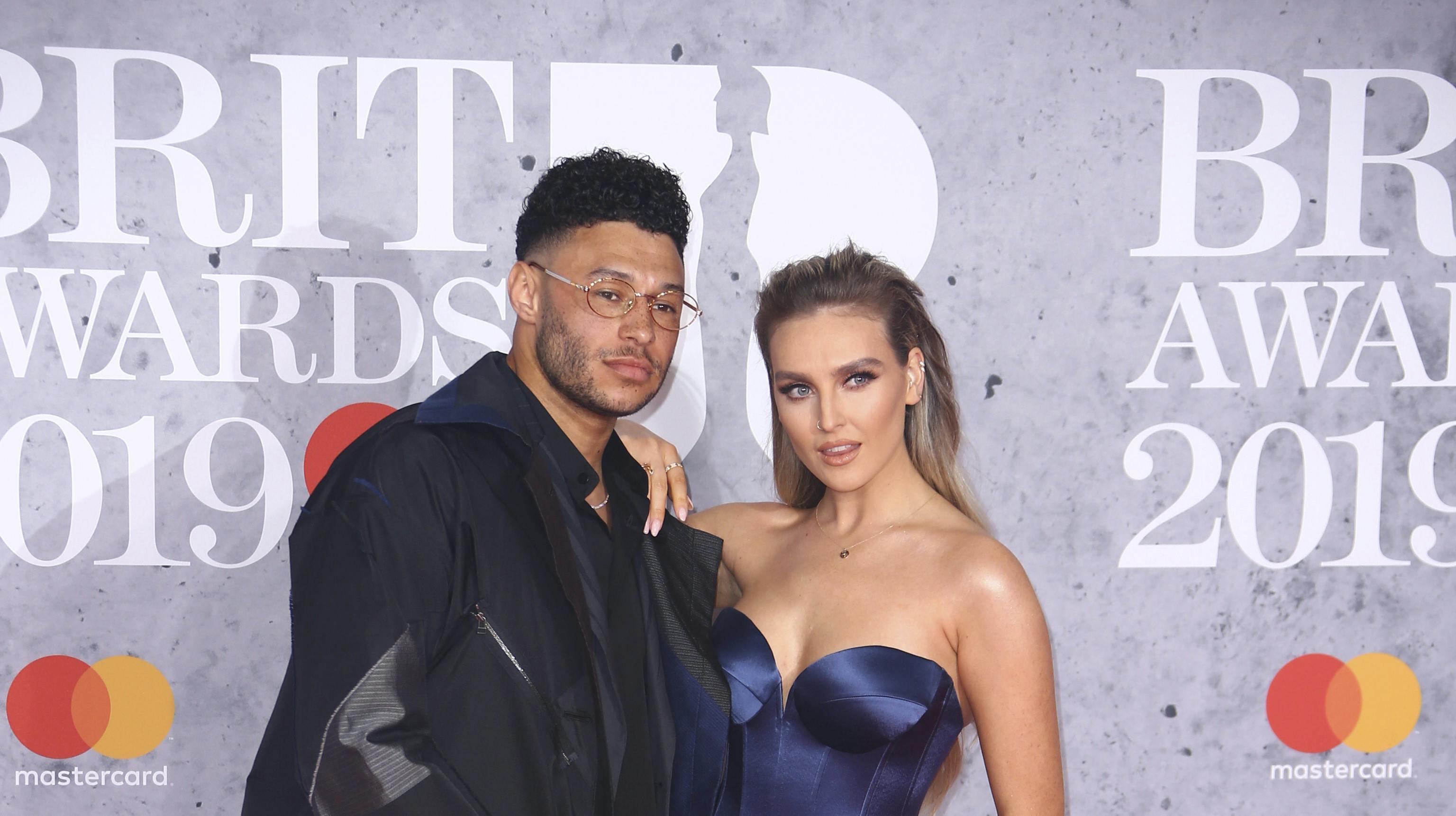 Alex Oxlade-Chamberlain and Perrie Edwards poses for photographers upon arrival at the Brit Awards in London, Wednesday, Feb. 20, 2019. (Photo by Joel C Ryan/Invision/AP)