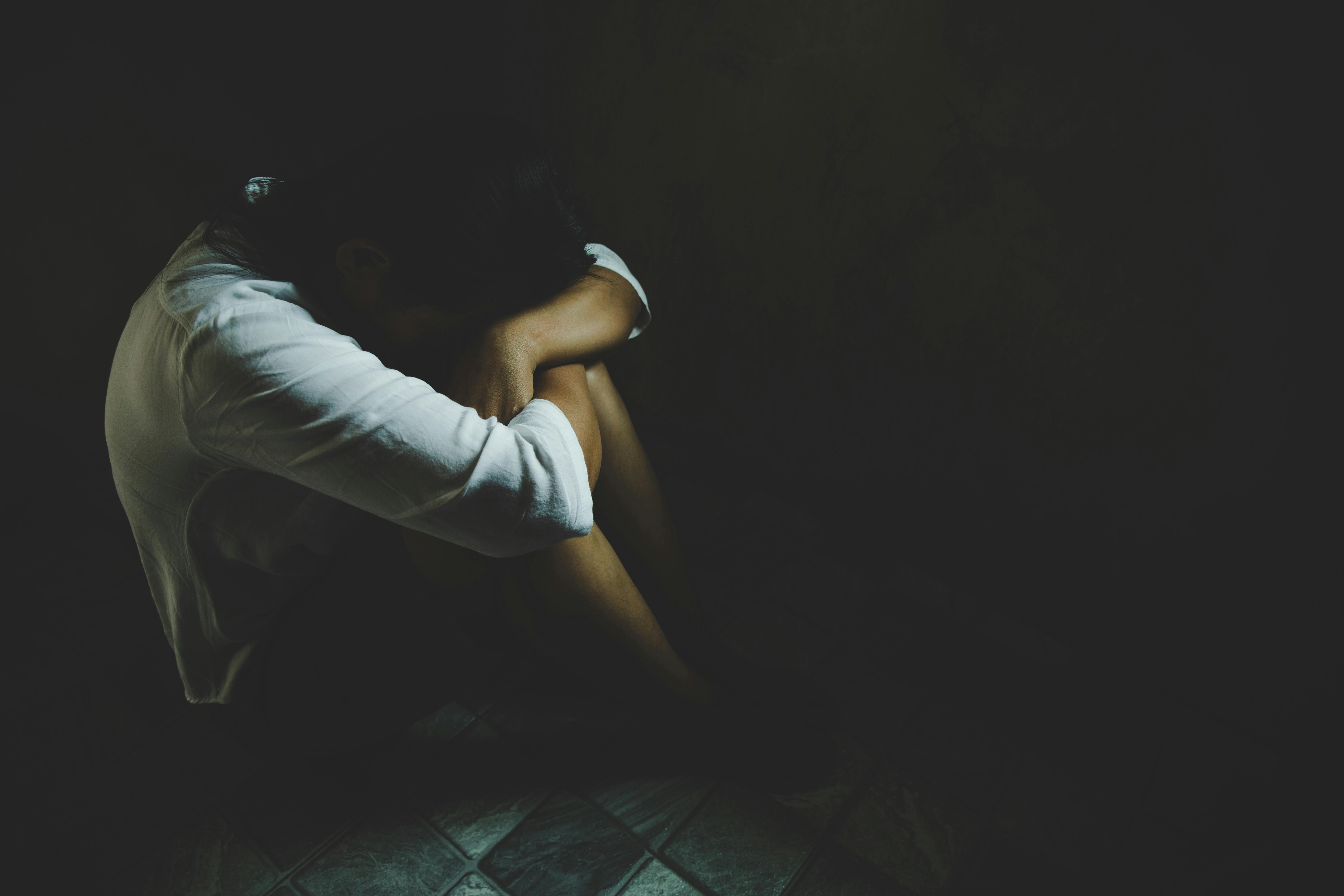 Abused young woman trying to hide and defend herself, Woman bondage in angle of abandoned building image blur , stop violence against Women, international women's day
