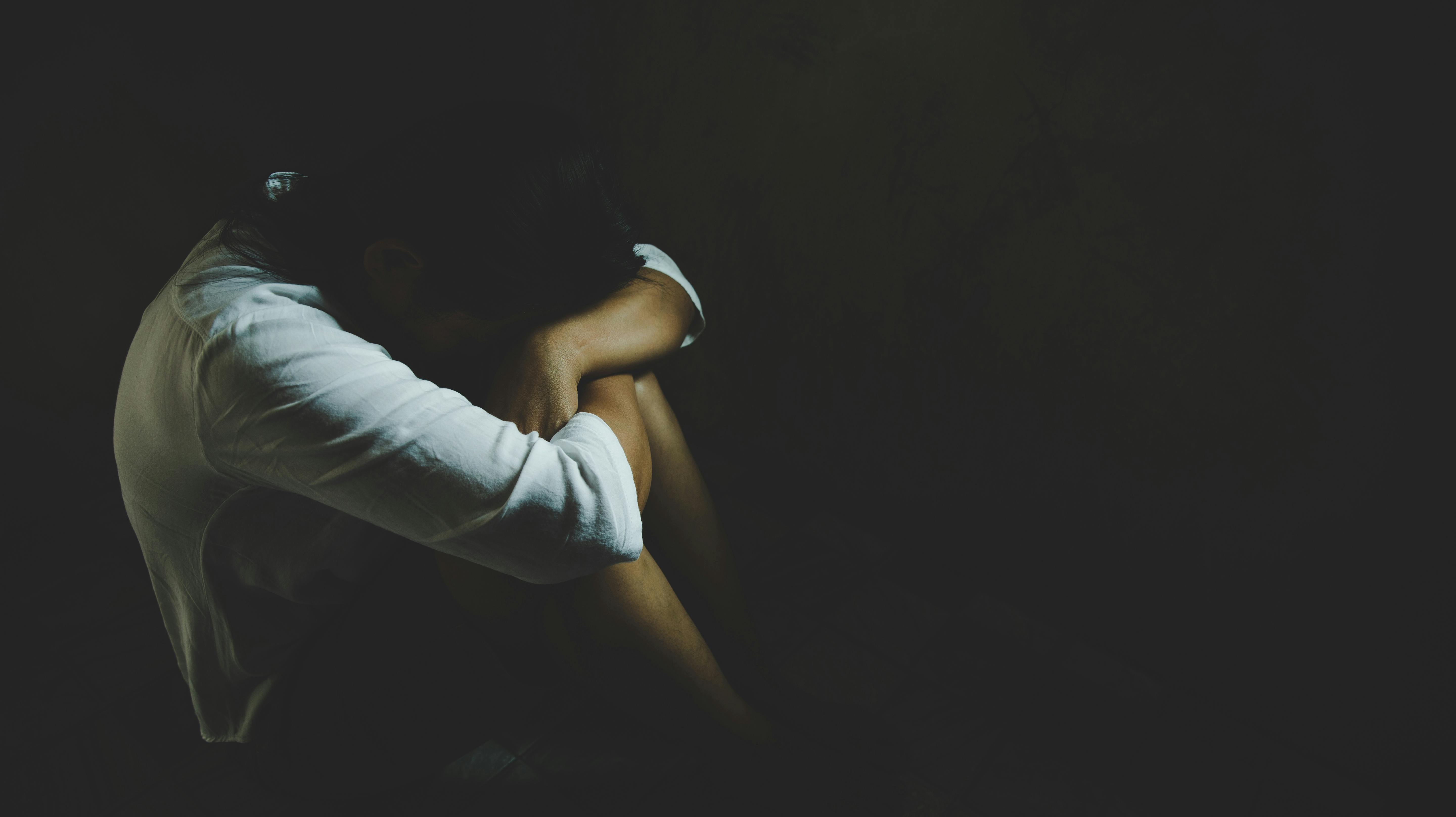 Abused young woman trying to hide and defend herself, Woman bondage in angle of abandoned building image blur , stop violence against Women, international women's day