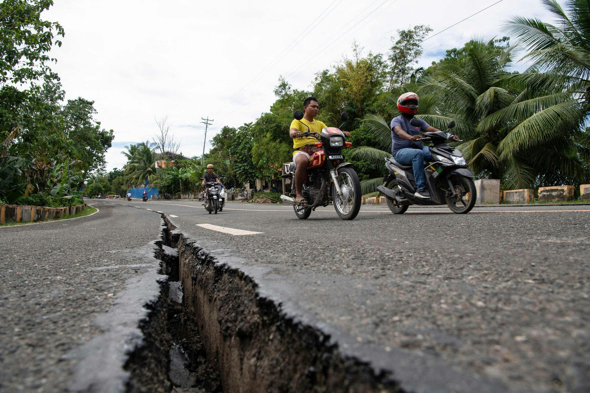 TOPSHOT - Motorists pass a crack