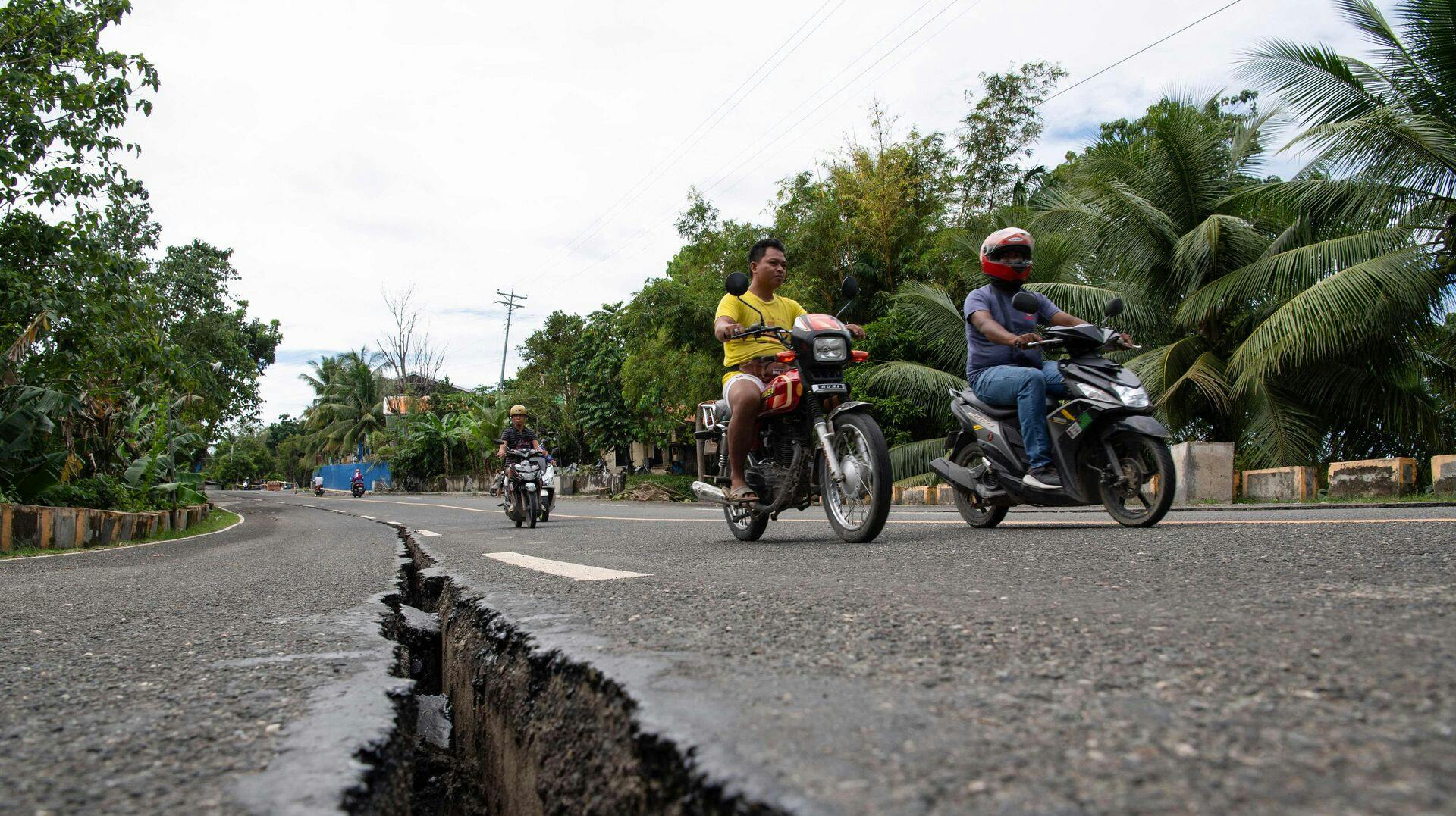 TOPSHOT - Motorists pass a crack