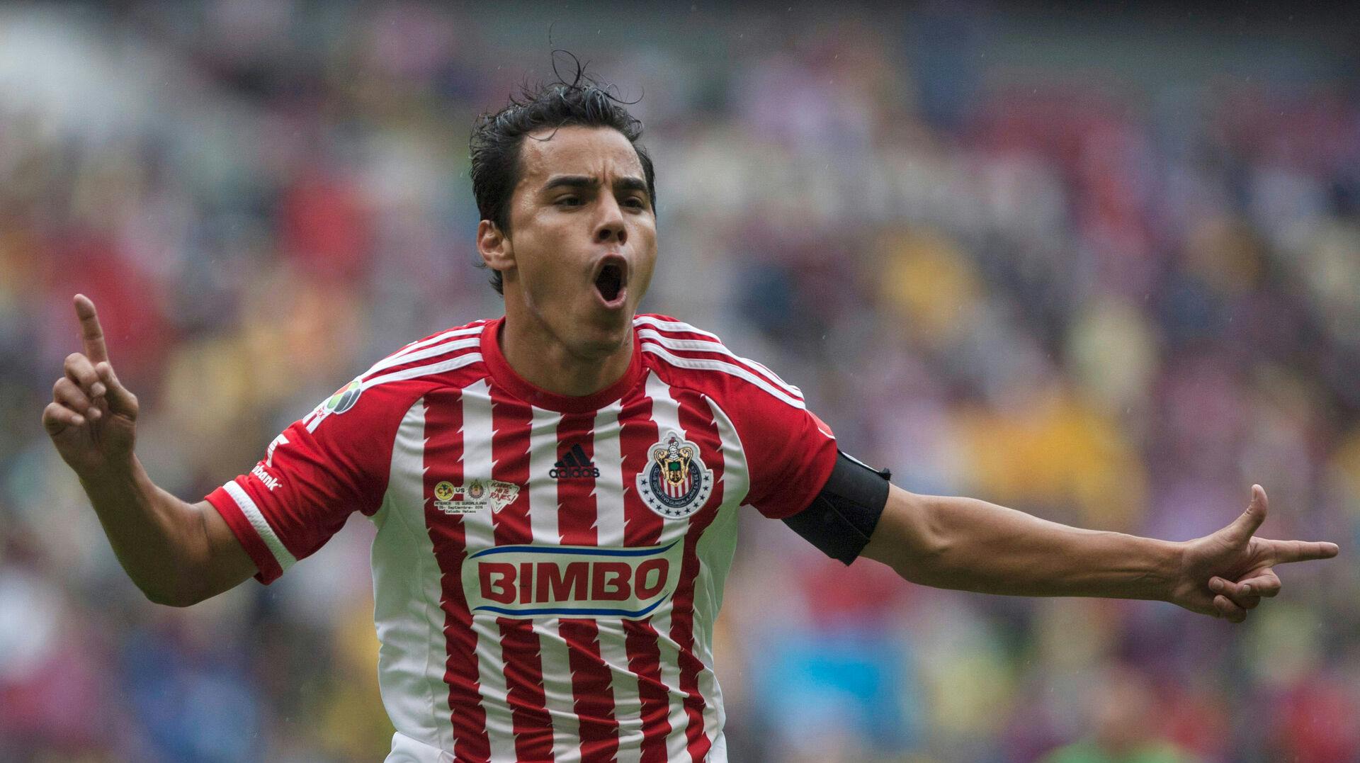 FILE - Chivas' Omar Bravo celebrates his goal against America during a Mexican soccer league match in Mexico City, Sept. 26, 2015. (AP Photo/Christian Palma, File)