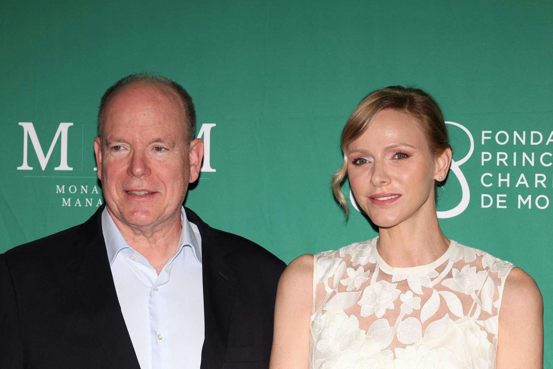 Prince's Albert II of Monaco and Princess Charlene of Monaco attend the traditional '19th hole' of the Princess of Monaco Cup charity golf tournament at the Place du Casino in Monaco, on September 16, 2025. (Photo by Valery HACHE / AFP) / NO TABLOIDS
