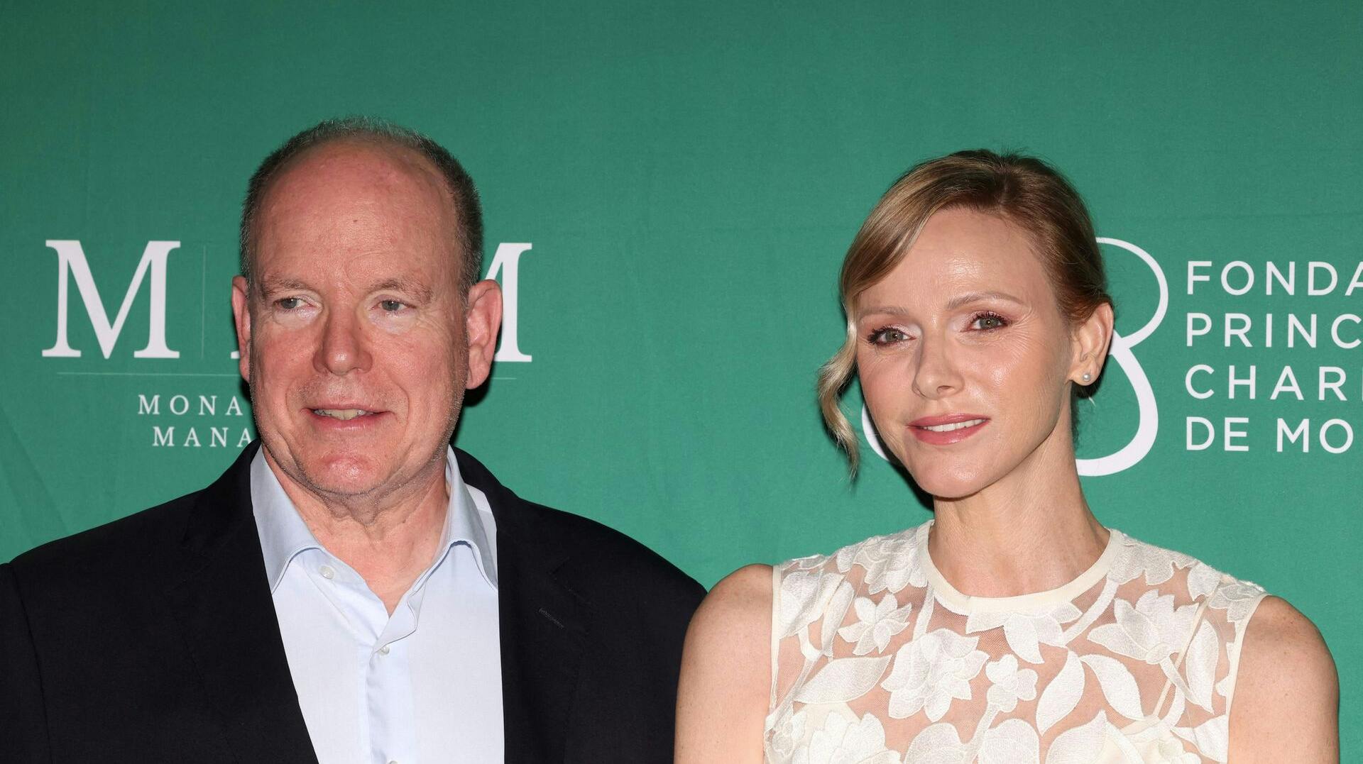 Prince's Albert II of Monaco and Princess Charlene of Monaco attend the traditional '19th hole' of the Princess of Monaco Cup charity golf tournament at the Place du Casino in Monaco, on September 16, 2025. (Photo by Valery HACHE / AFP) / NO TABLOIDS