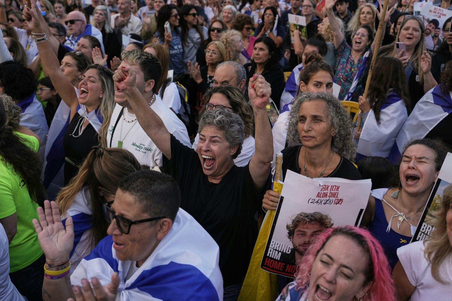 People react as they gather to watch a live broadcast of Israeli hostages released from Gaza at a plaza known as hostages square in Tel Aviv, Israel, Monday, Oct. 13, 2025. The release took place as part of a cease-fire agreement between Israel and Hamas. (AP Photo/Oded Balilty)
