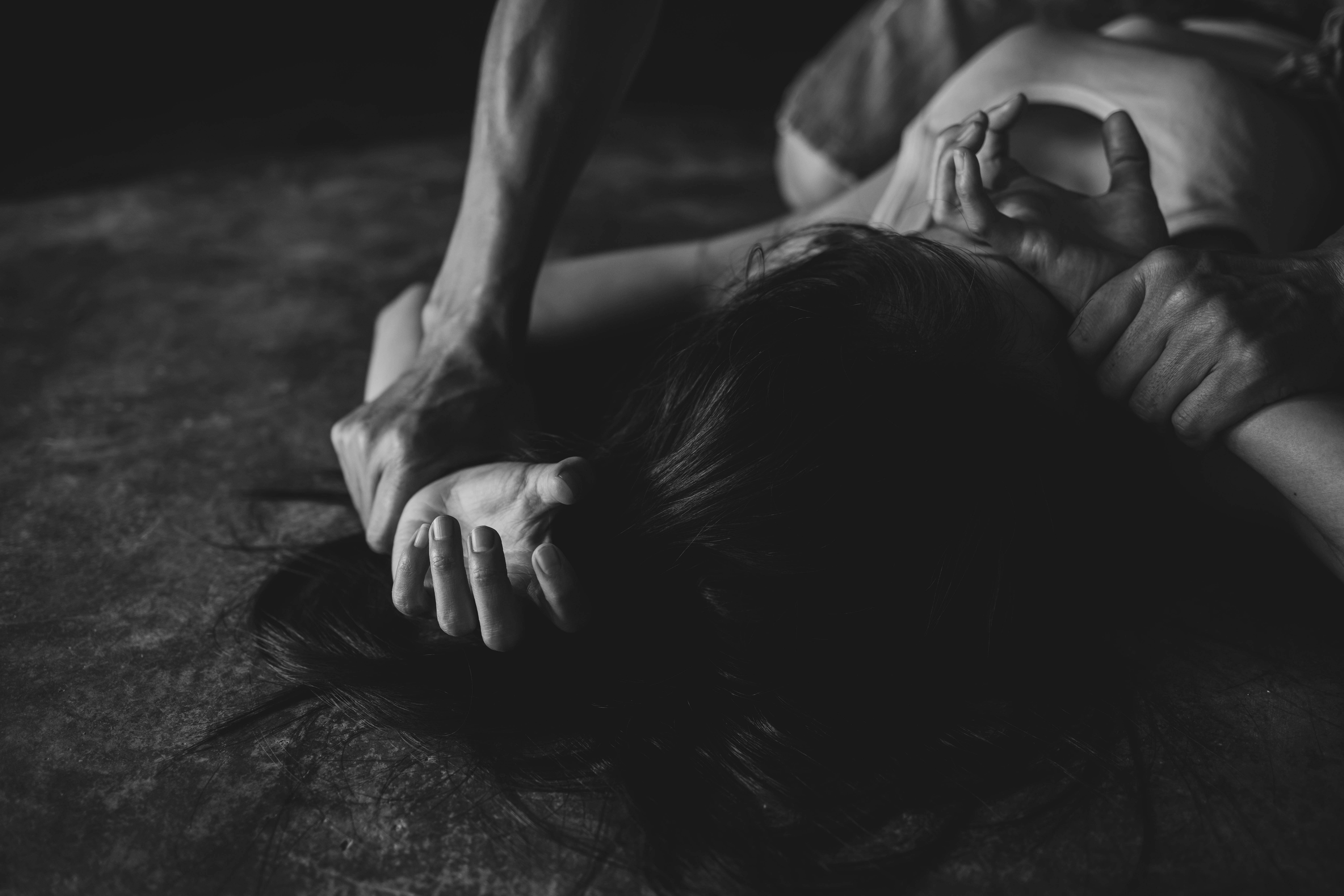 Sexual abuse with a man attacking to a scared woman in a dark place, rape.