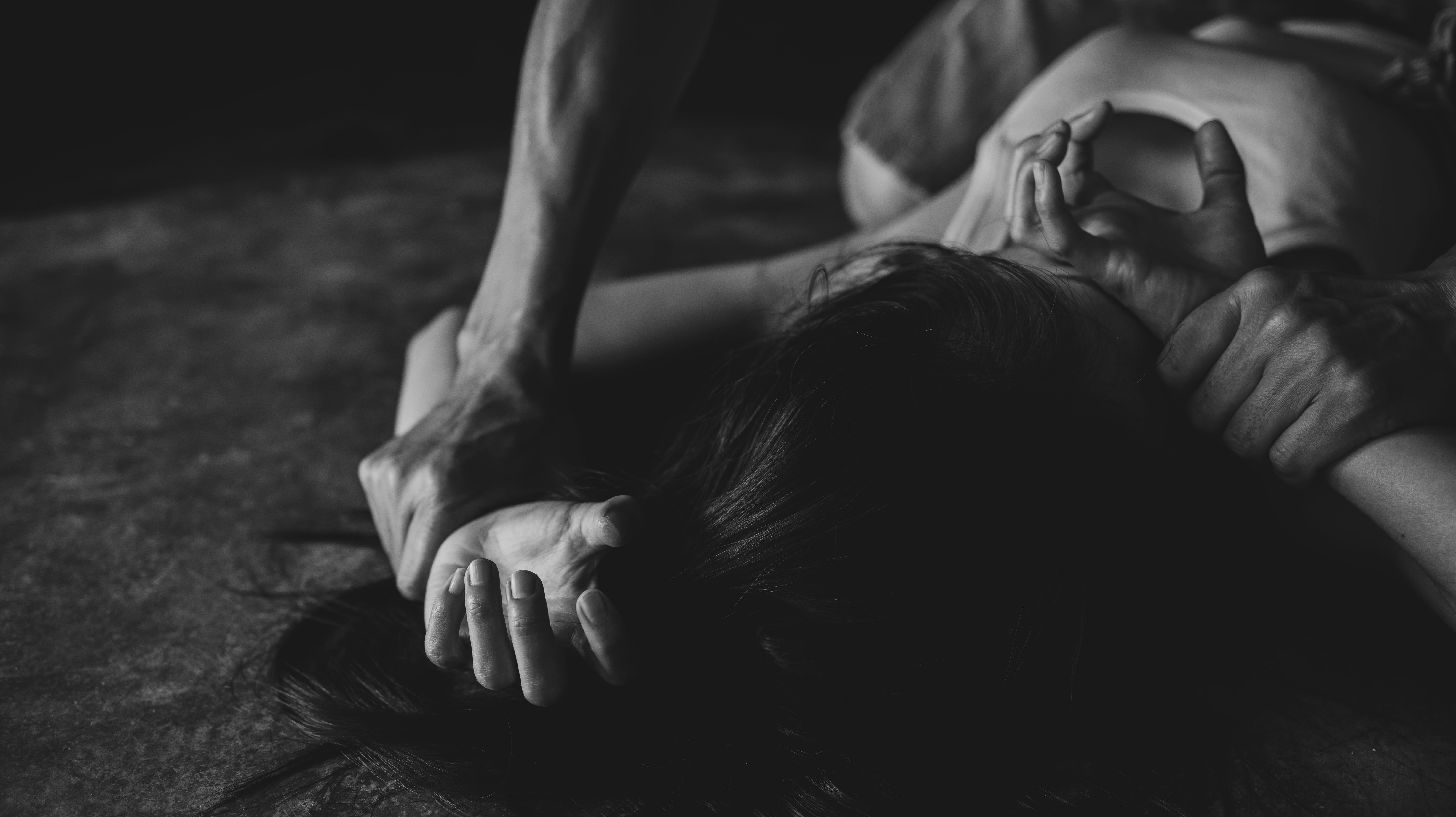 Sexual abuse with a man attacking to a scared woman in a dark place, rape.