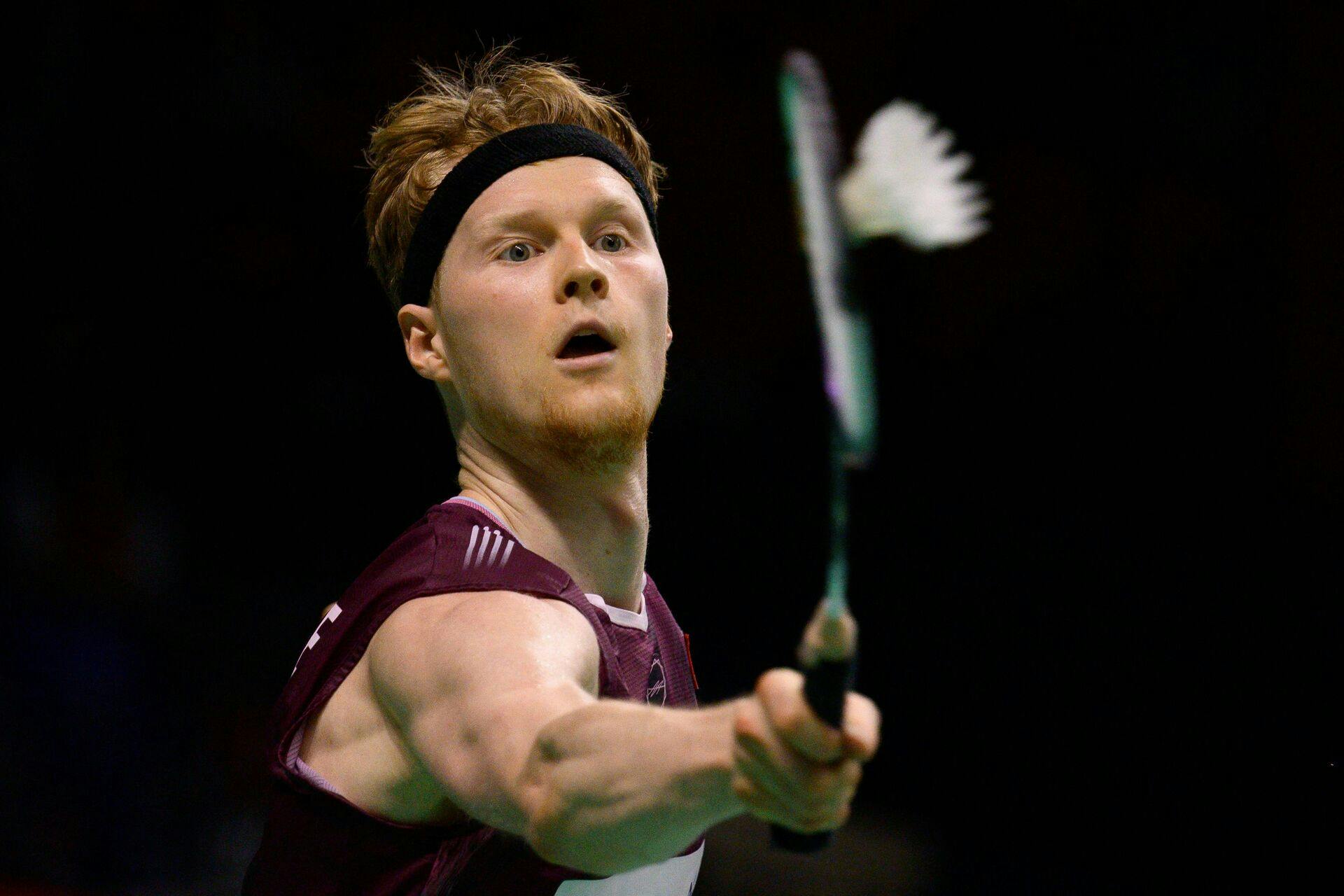 Denmark's Anders Antonsen returns the shuttlecock to Taiwan's Chou Tien-chen during their men's singles semi-final match at the Korea Open badminton tournament in Suwon on September 27, 2025. (Photo by ANTHONY WALLACE / AFP)