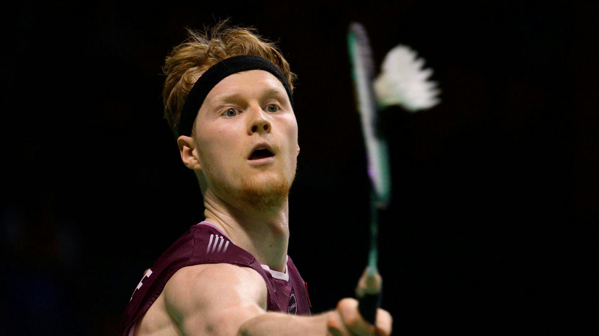 Denmark's Anders Antonsen returns the shuttlecock to Taiwan's Chou Tien-chen during their men's singles semi-final match at the Korea Open badminton tournament in Suwon on September 27, 2025. (Photo by ANTHONY WALLACE / AFP)