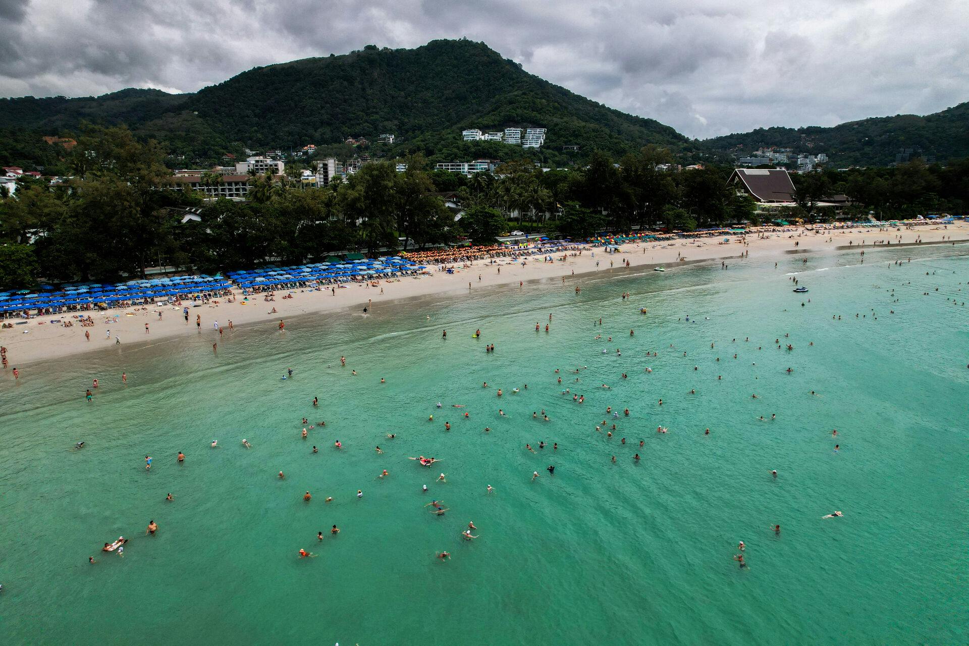 A drone view shows tourists at Kata beach in Phuket, Thailand, November 25, 2024. REUTERS/Napat Wesshasartar