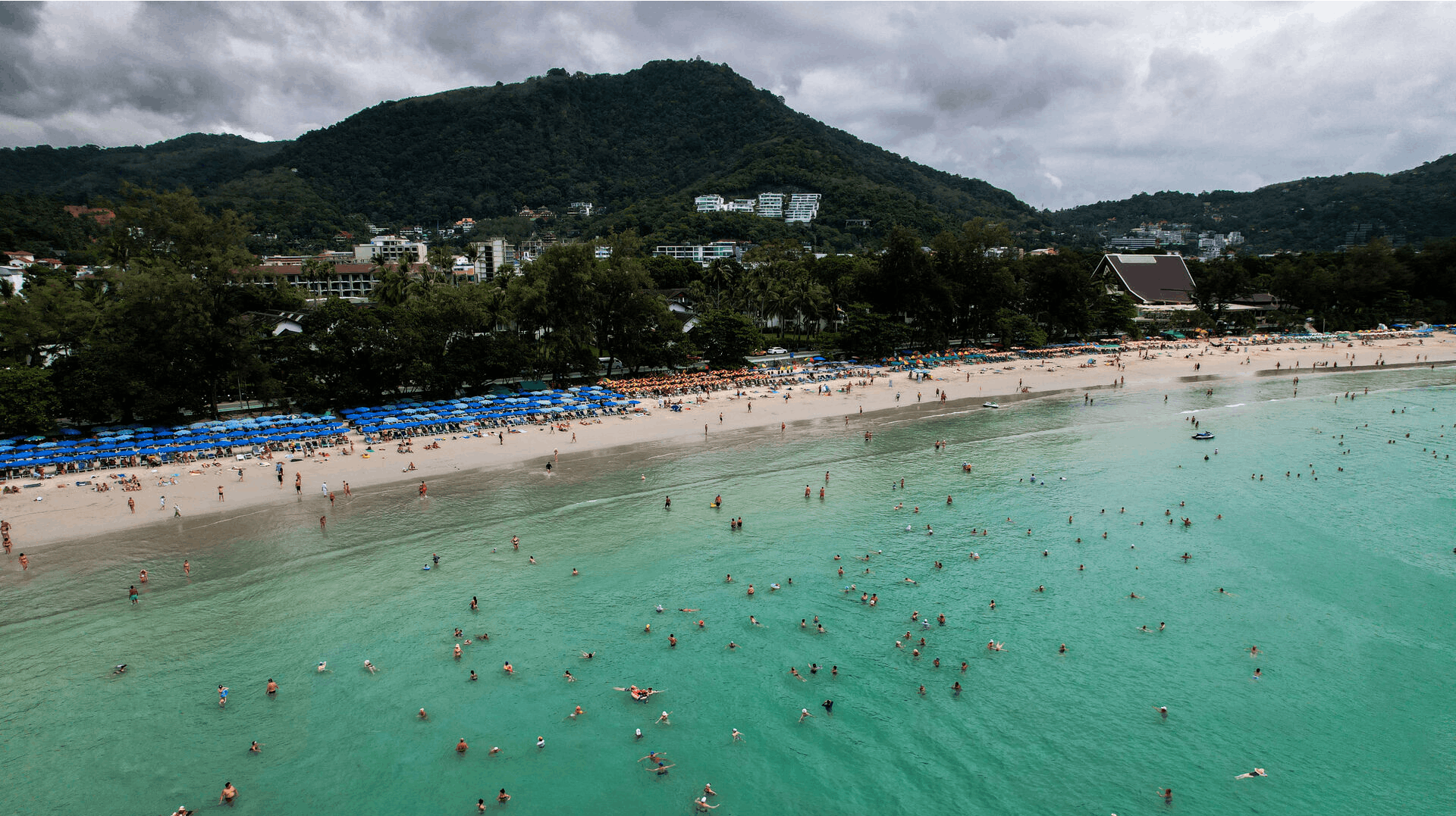 A drone view shows tourists at Kata beach in Phuket, Thailand, November 25, 2024. REUTERS/Napat Wesshasartar