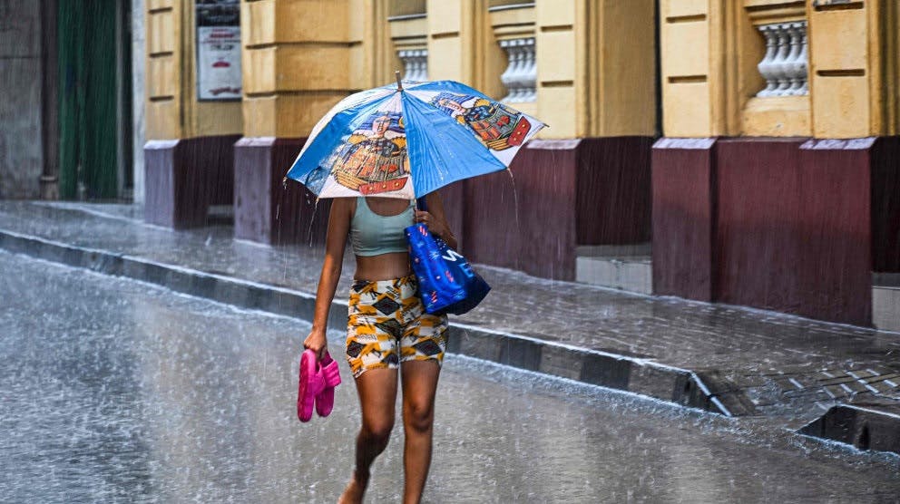 En kvinde går ned ad en ellers mennesketom gade i Santiago de Cuba, inden orkanen Melissa går i land. - Foto: Yamil Lage/Ritzau Scanpix