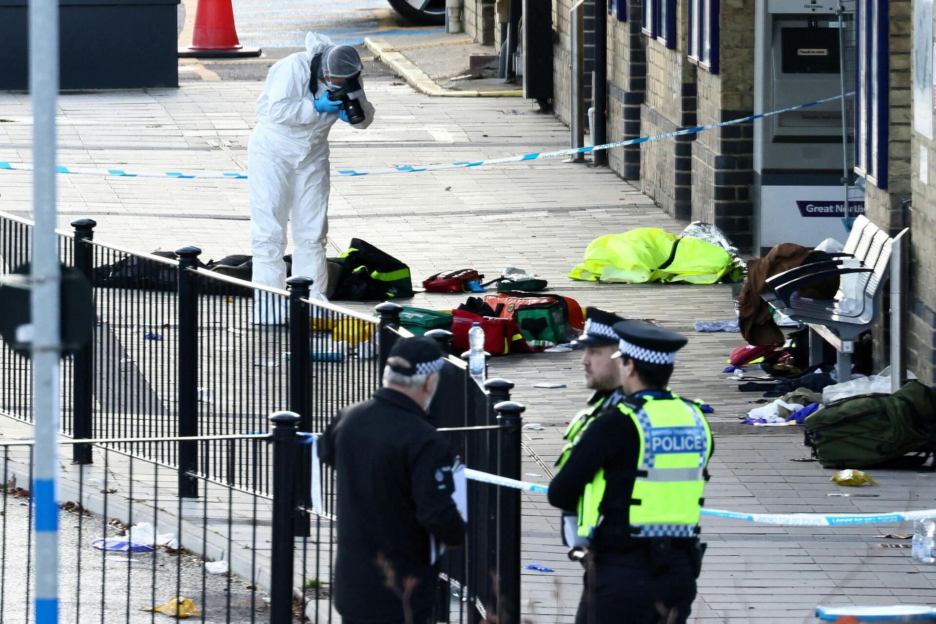 A forensic officer takes pictures at the cordoned-off area at Huntingdon Station, following a series of stabbings on a London North Eastern Railway (LNER) train, near Cambridge, Britain, November 2, 2025. REUTERS/Jack Taylor