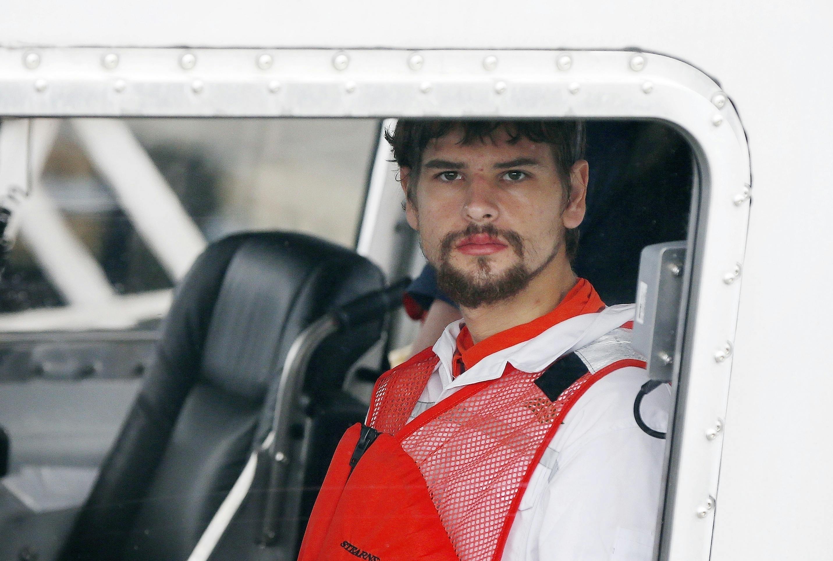 FILE - This Sept. 27, 2016 file photo shows Nathan Carman arriving in a small boat at the US Coast Guard station in Boston. A New Hampshire judge is scheduled on Friday, Dec. 15, 2017, to hear arguments to dismiss a lawsuit accusing Carman of killing his millionaire grandfather and possibly his mother to collect an inheritance. No one has been arrested. Carman has denied any involvement in either case. (AP Photo/Michael Dwyer, File)