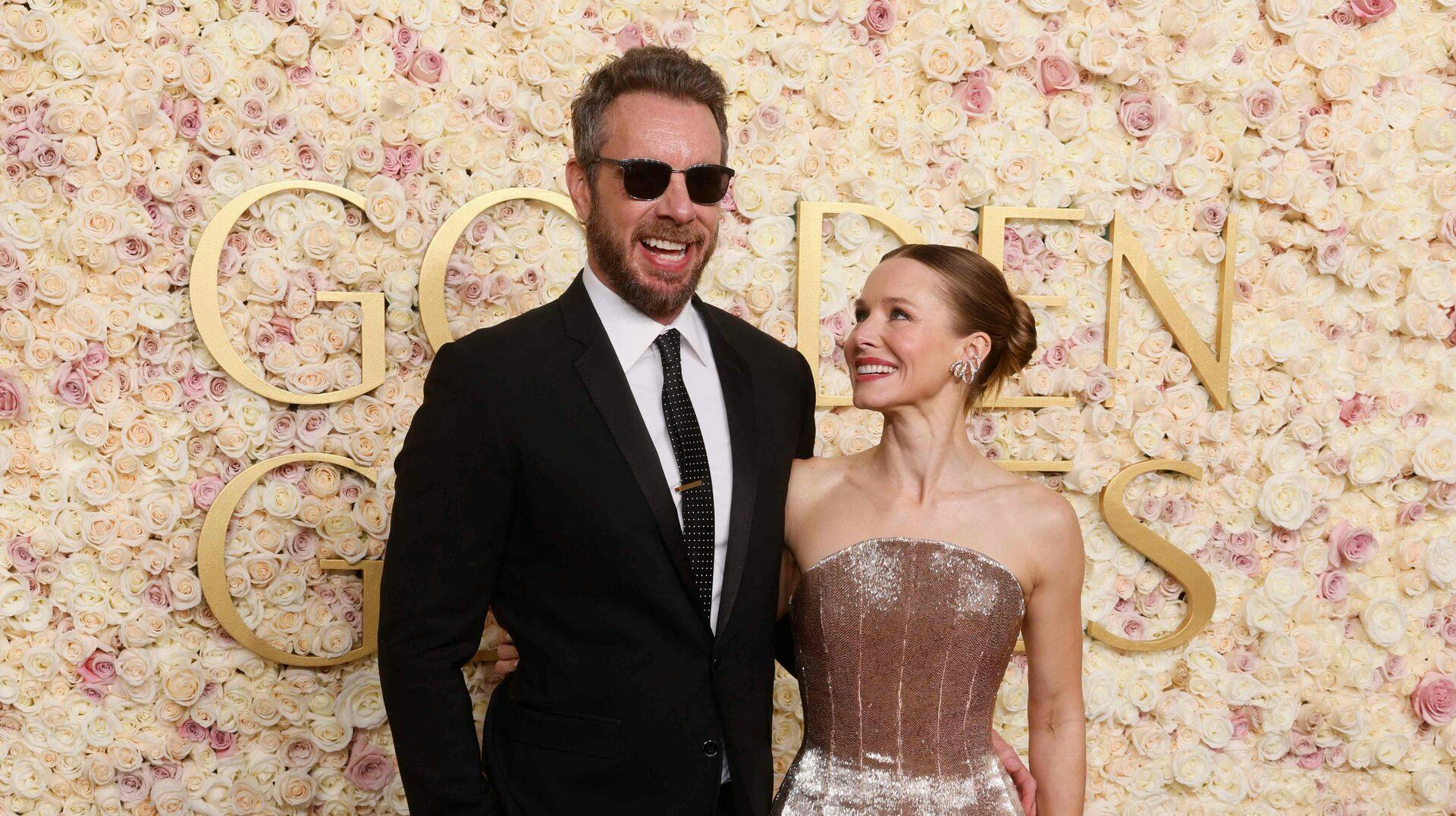 US actress Kristen Bell (R) and US actor Dax Shepard arrive for the 82nd annual Golden Globe Awards at the Beverly Hilton hotel in Beverly Hills, California, on January 5, 2025. (Photo by Etienne LAURENT / AFP)