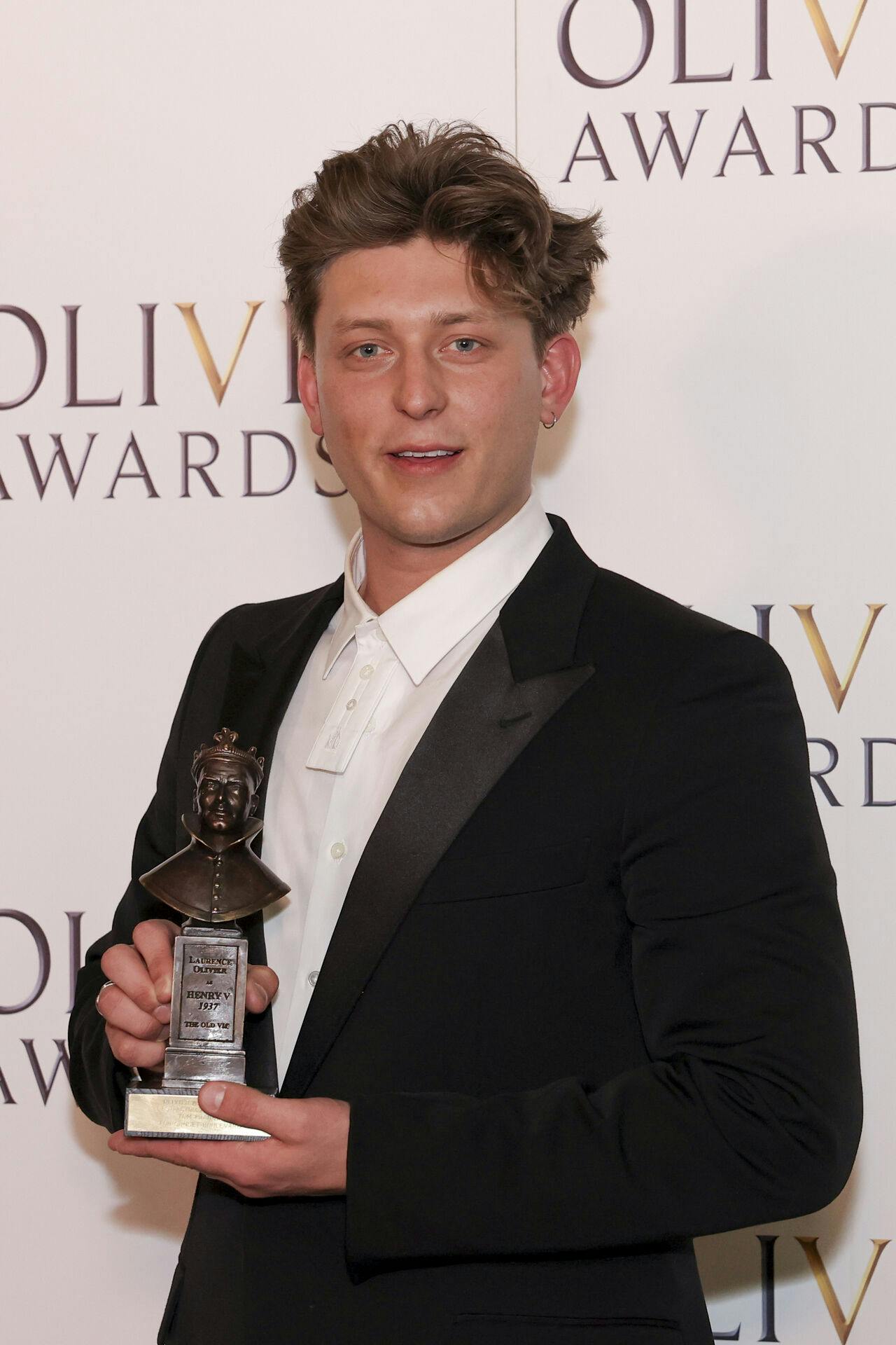 Tom Francis, winner of the best actor in a musical award for "Sunset Boulevard", poses for photographers in the winner's room during the Olivier Awards on Sunday, April 14, 2024, in London. (Photo by Vianney Le Caer/Invision/AP)