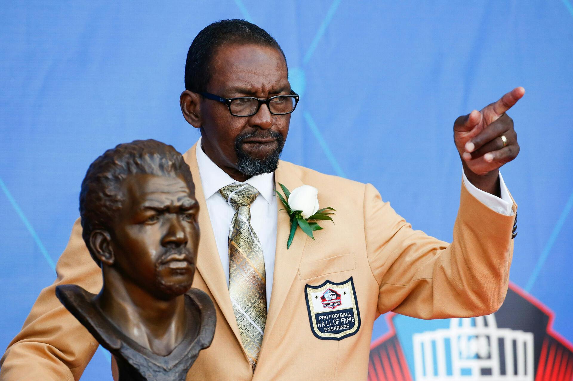 FILE - Former NFL player Kenny Easley poses with a bust of himself during an induction ceremony at the Pro Football Hall of Fame, Saturday, Aug. 5, 2017, in Canton, Ohio. (AP Photo/Ron Schwane, File)